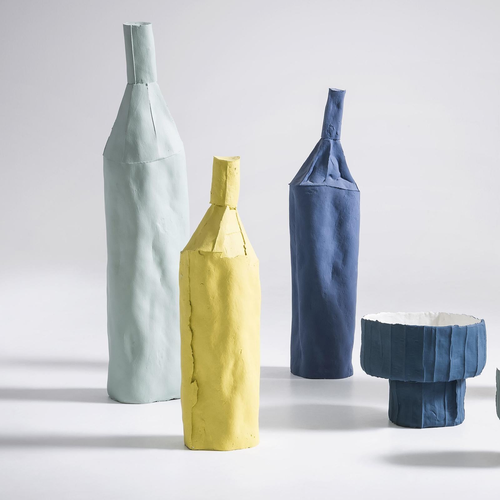 Merging tradition with innovation, this handcrafted sculpture will be a sophisticated accent on any table with its captivating and unique allure. Its bottle-shaped silhouette has an elegant royal blue matte finish that enhances its minimal design