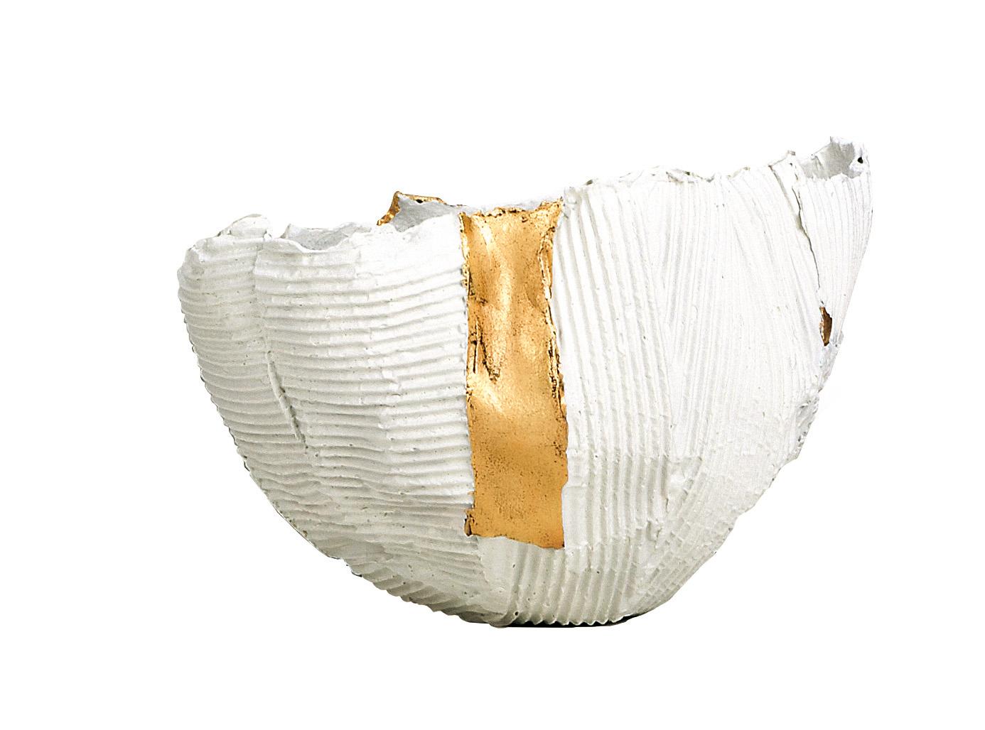 Fashioned entirely by hand, this irregularly shaped bowl will be a timeless centerpiece in a modern dining room, living room, or entryway. Characterized by a unique three-dimensional texture, it features expressive horizontal and vertical ridges and