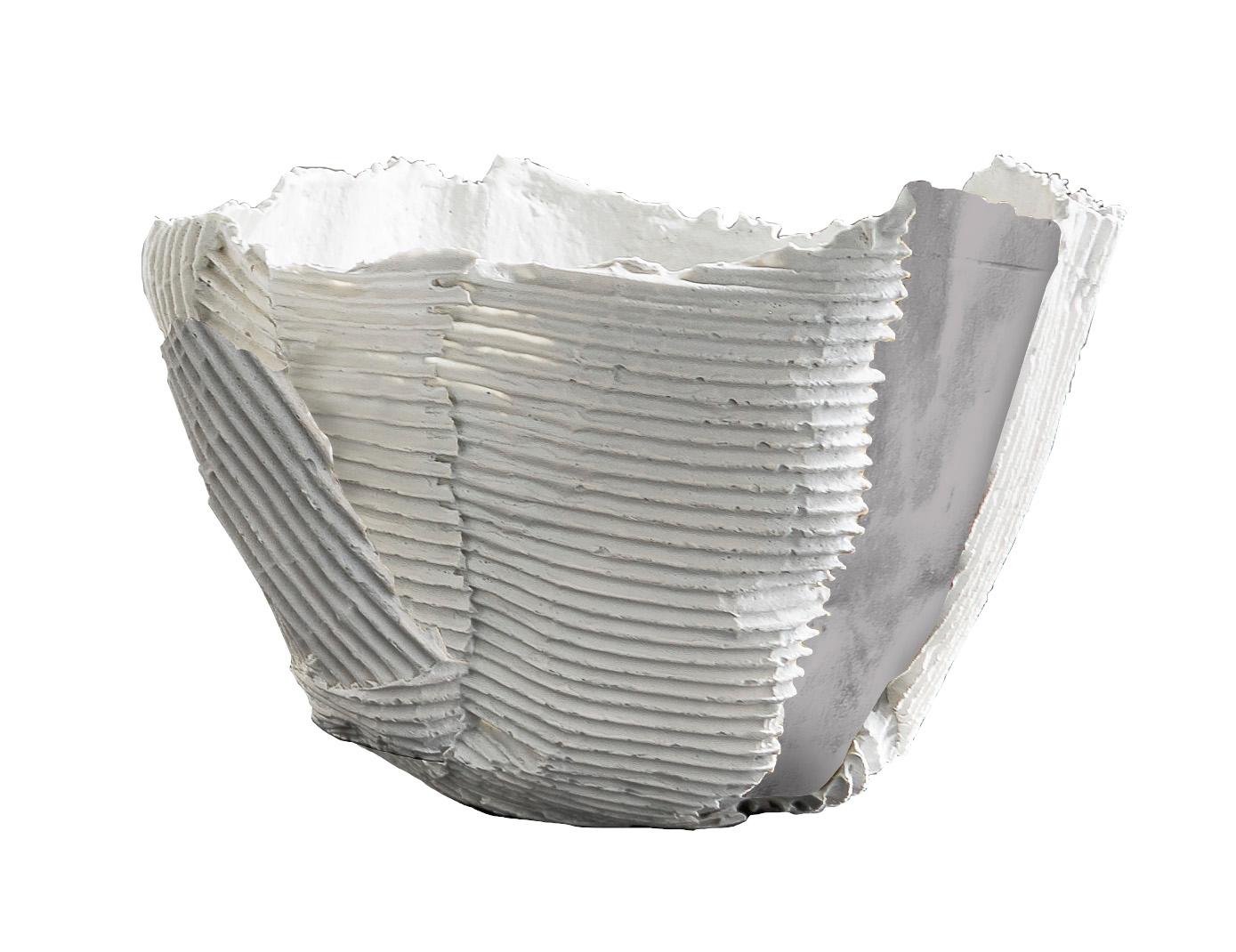 The bowl boasts randomly drawn horizontal and vertical ridges and a single smooth gray panel, creating a visually striking work of functional decor. Entirely handmade of paper clay, a combination of paper pulp and fiber mixed into the ceramic base