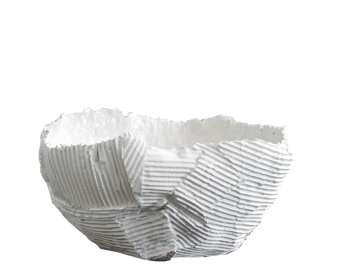 Reminiscent of whimsical papier mâché creations, this alluring bowl redefines the aesthetic character of home decor. This pearl-white bowl is fashioned of paper clay, a material that incorporates paper pulp and natural fibers into the clay to create