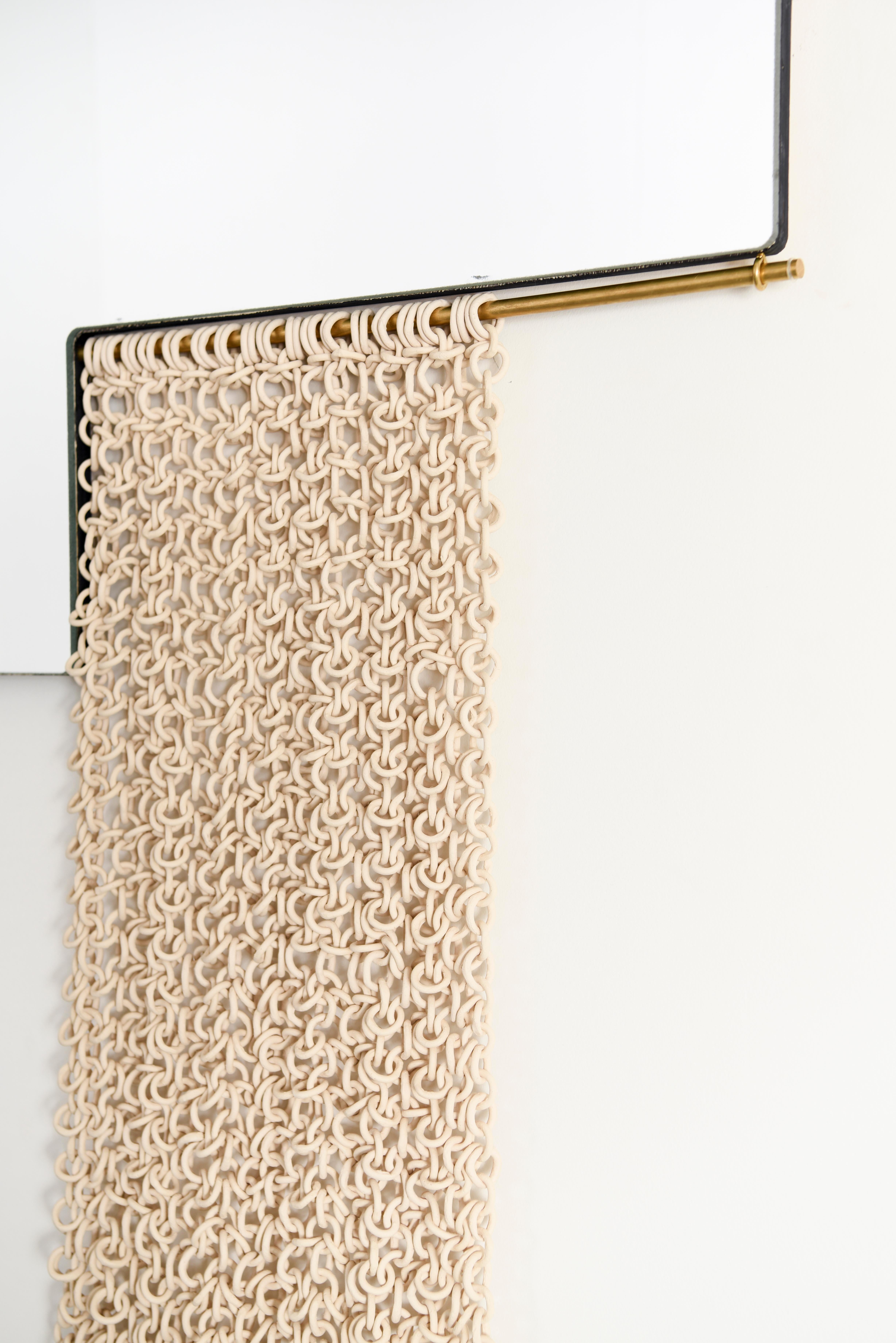 The L-Mirrors are a set of sculptural mirrors with brass rods that hold ceramic chainmail curtains. The ceramic chainmail has been individually handmade, creating an organic fabric contrasting the geometry of the mirrors. 


The mirrors are 30
