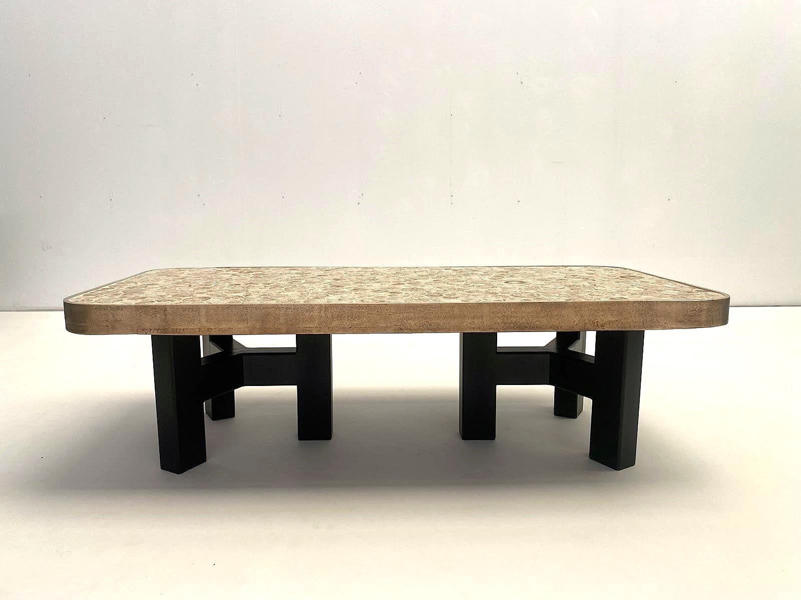 Contemporary coffee tables by Belgian artist ALIETTE VLIERS. These tables feature a shelf with many different sized ceramic circles combined with brass circles. The whole is framed by a bronze hoop. The top rests elegantly on a black steel tripod