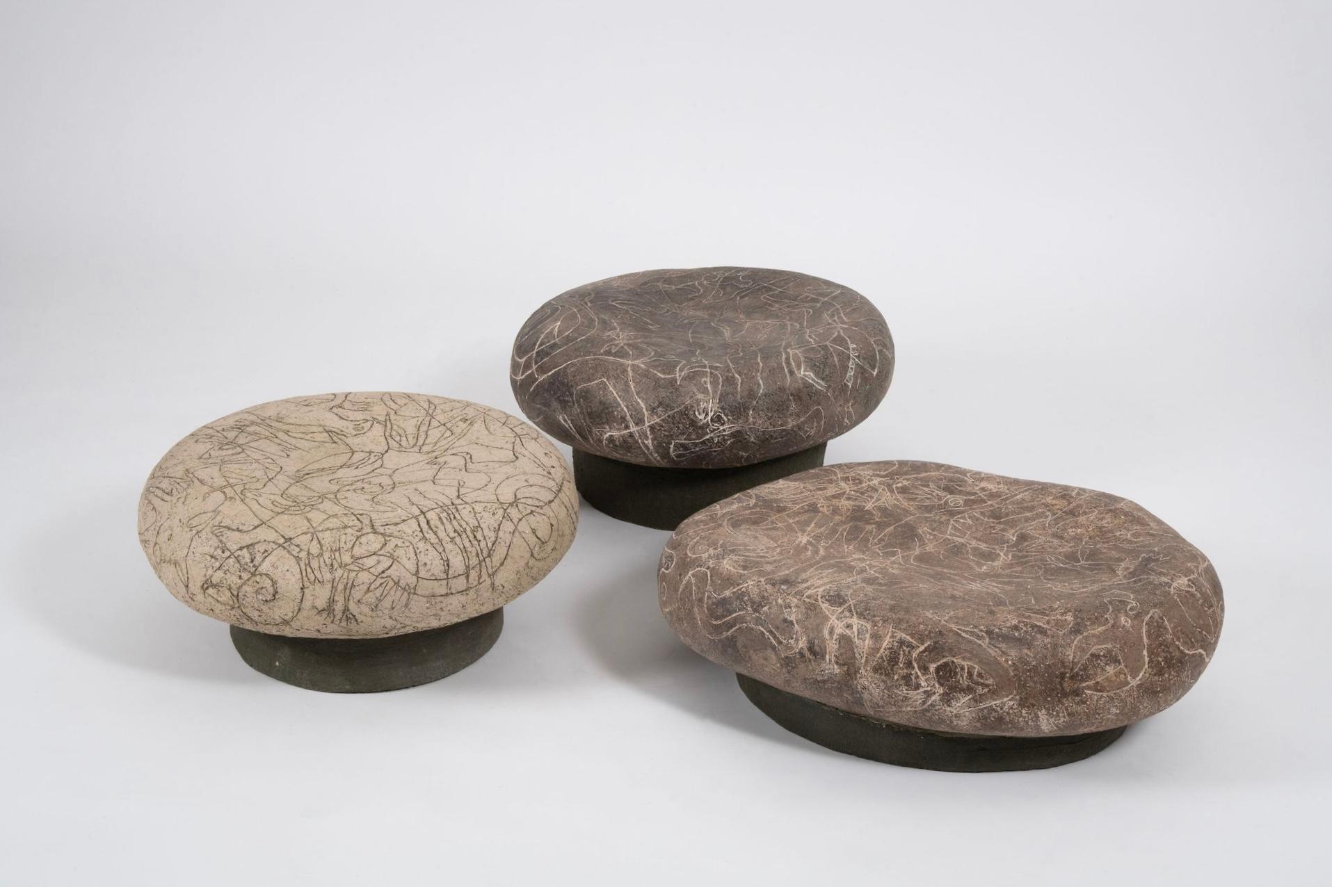 Pebble Tables by Agnès Debizet 
Material: Carved stoneware
Dimensions: H 20/24/25 x L 61/50/52 x 50/50/51 cm
Year: 2022
Type: one-of-a-kind

The simple yet powerful “Pebble Coffee Tables” made from ceramic by Agnès Debizet retains a sculptural