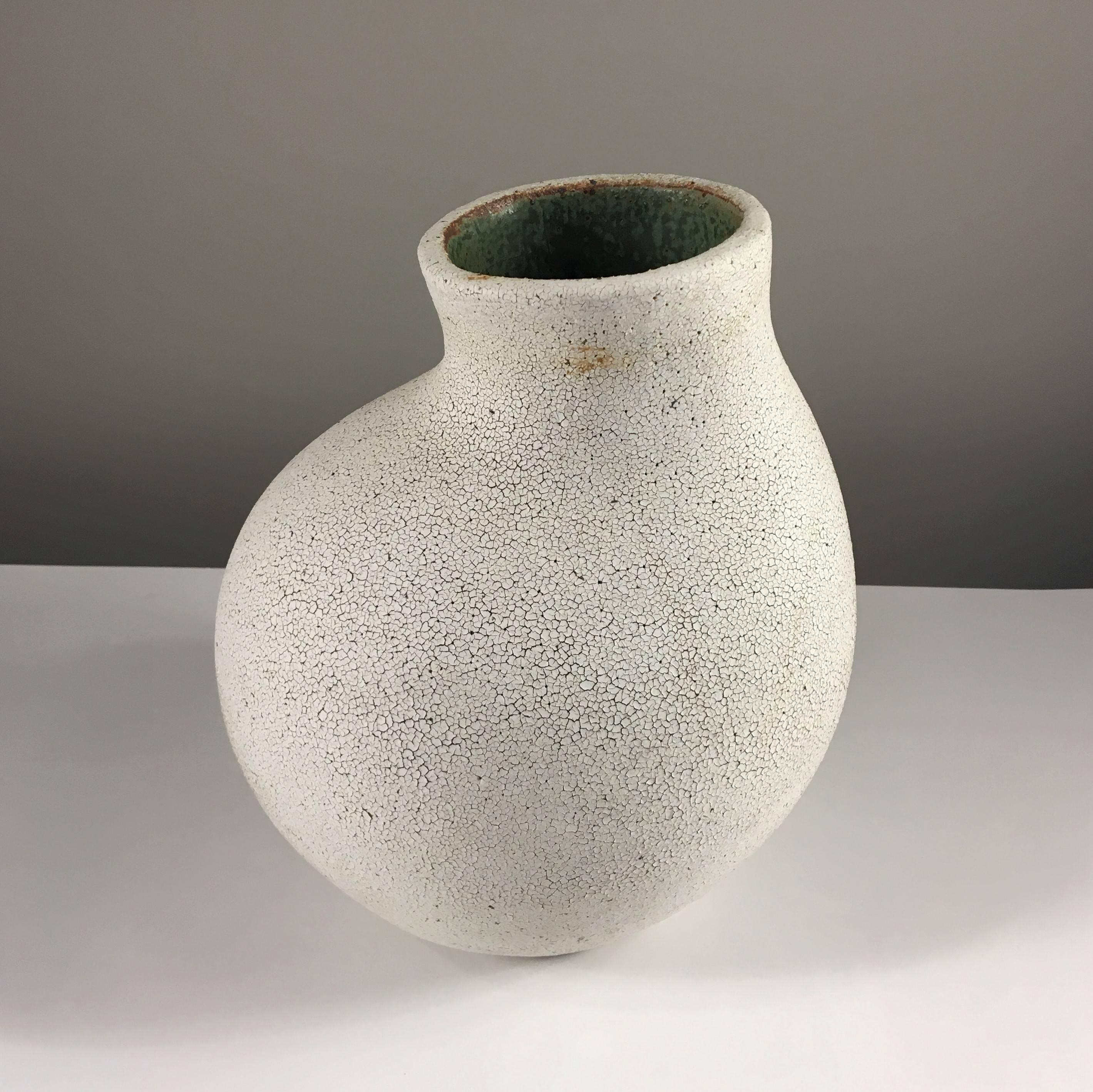 Contemporary ceramic artist Yumiko Kuga's glazed stoneware curved neck vase no. 145 is part of her Crackle Series. All of the pieces in this series are hand-built and 100% handmade so they are one-of-a-kind and thus vary slightly from one another.