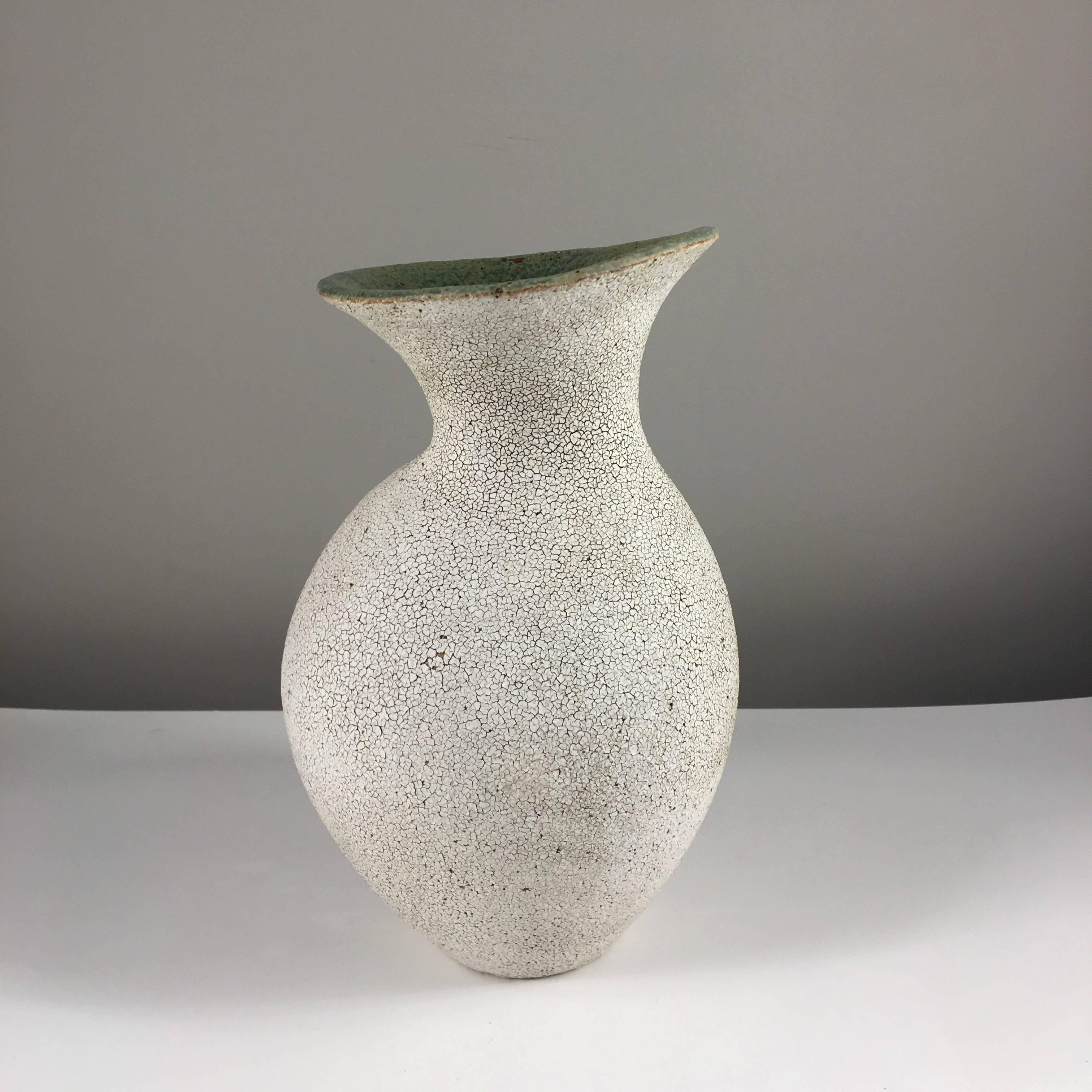 Contemporary ceramic artist Yumiko Kuga's glazed stoneware curved neck vase no. 160 is part of her Crackle series. All of the pieces in this series are hand-built and 100% handmade so they are one-of-a-kind and thus vary slightly from one another.