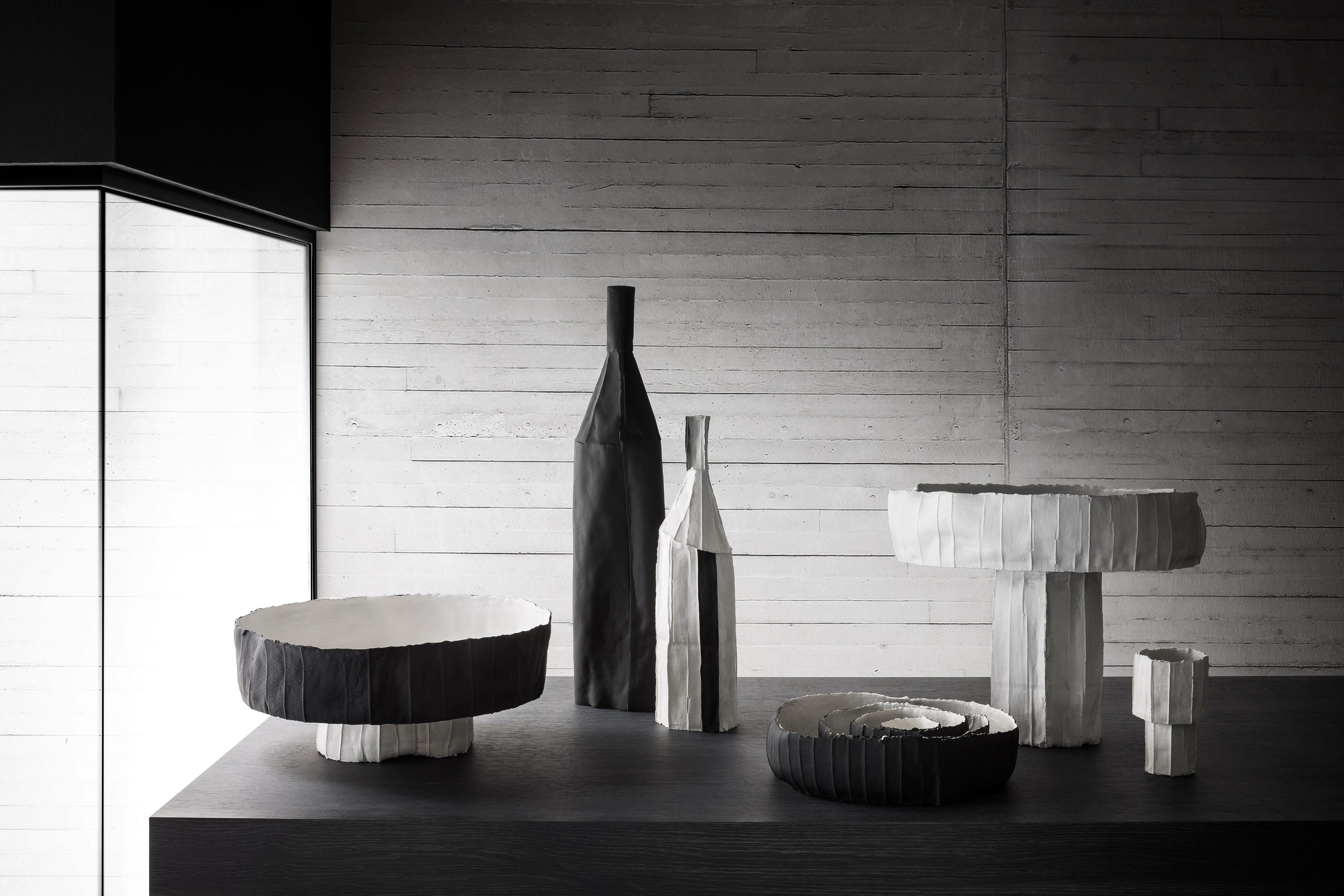A Classic bottle shape in a Classic black-and-white color block combination takes on a completely new look in this striking piece. Its unique texture comes from the paper clay, a material obtained by adding paper pulp and natural fibers to a clay