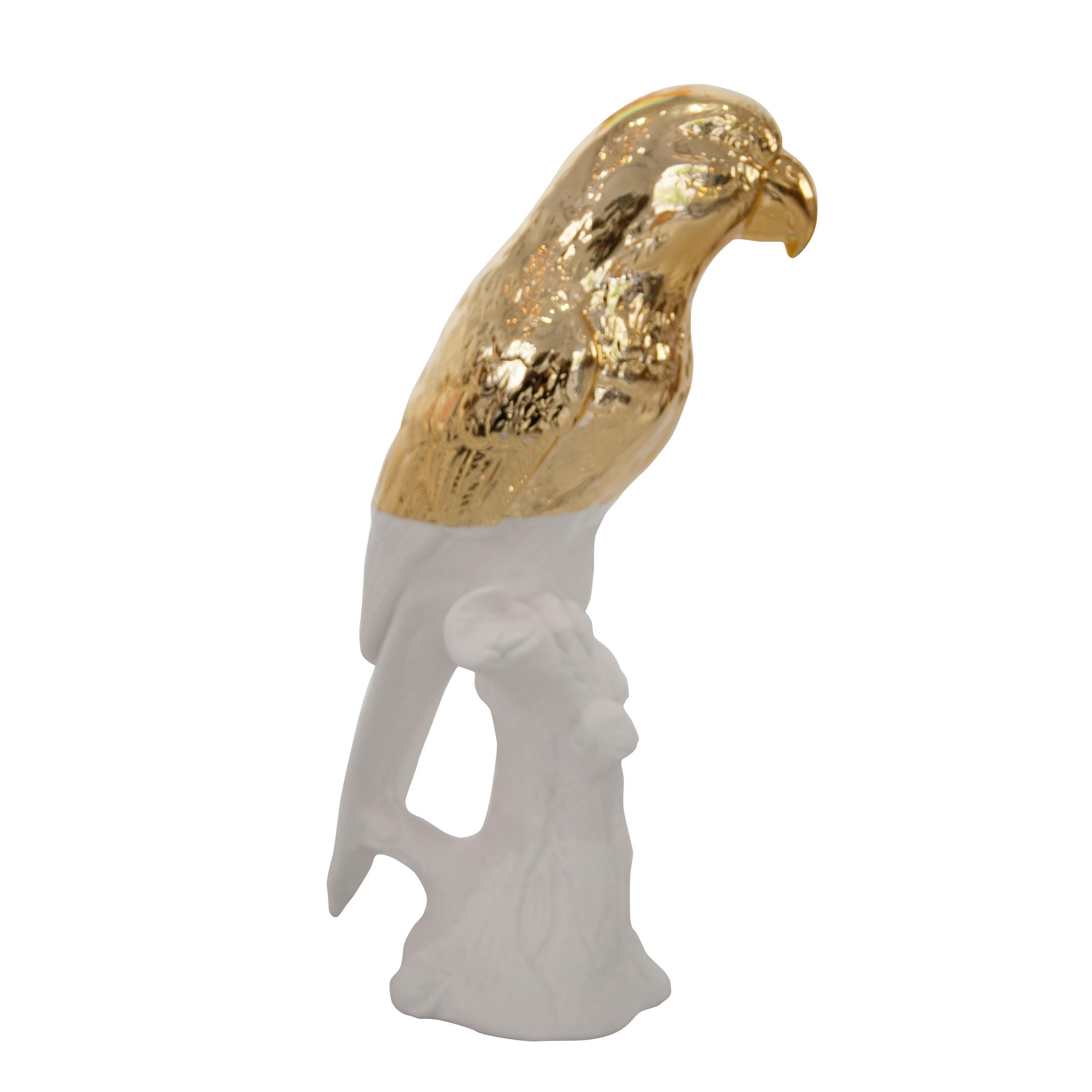 Ceramic parrot figure in white and gold finish.