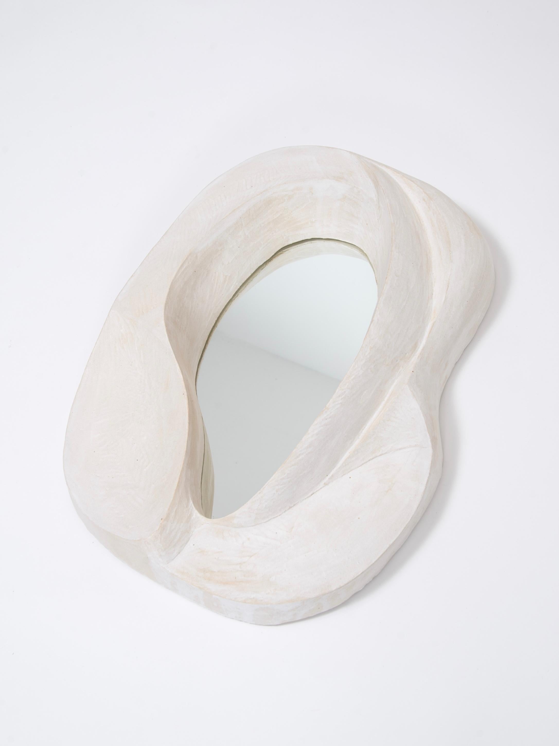 Faille Mirror by Natasha Dakhli
Material: Stoneware, white enamel
Dimensions: H 61 x 44 x 13 cm
Year: 2023

The carved mirror is  part of a small wall sculpture series. It was created around Natasha Dakhli’s inspiration of primitive architectures,