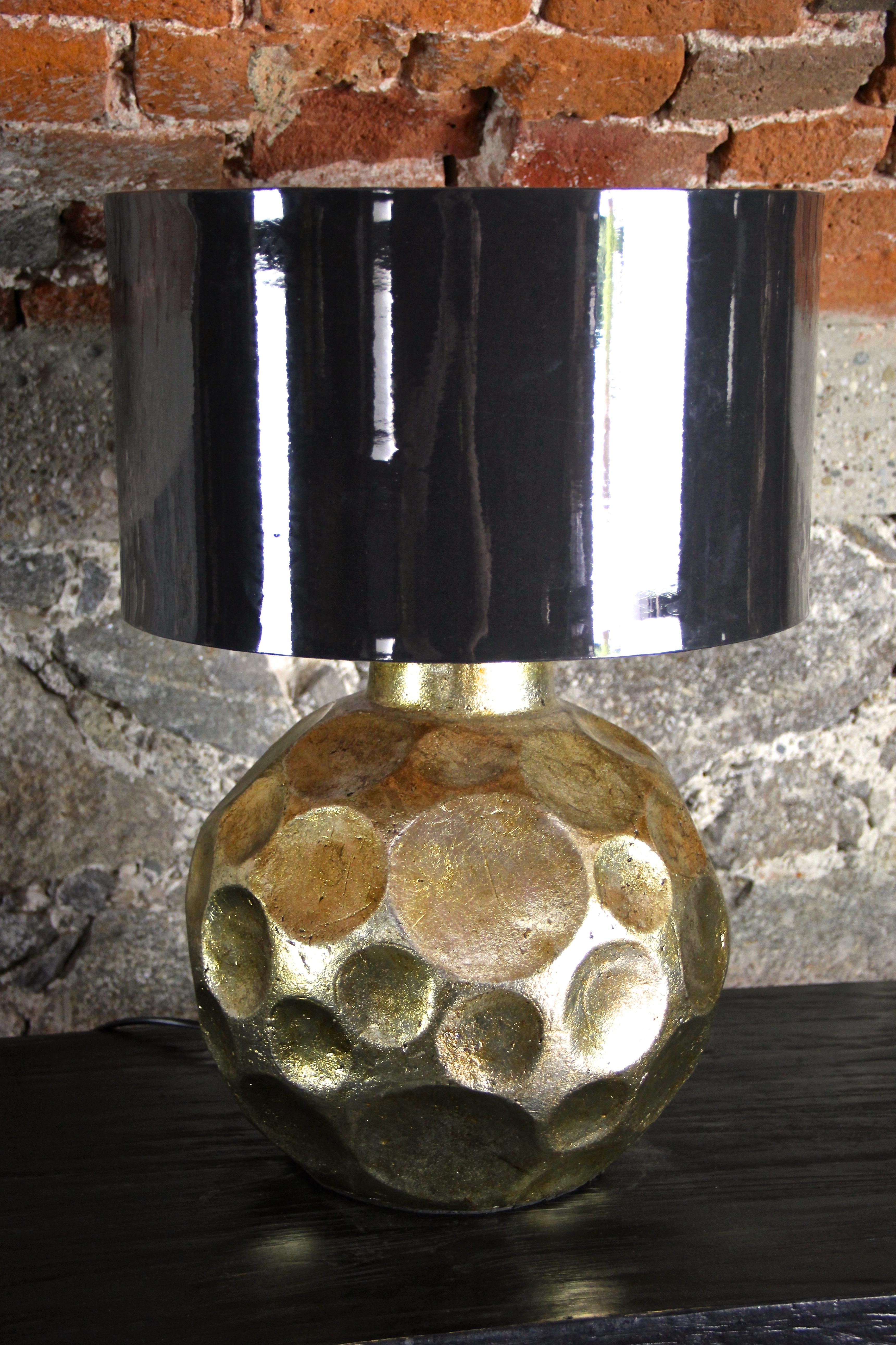 Decorative contemporary golden glazed ceramic table lamp. The great designed bulby ceramic body reminds on irregular formed honeycombs and shows a warm golden glazed surface, looking like it has a lovely patina. In combination with the dark grey