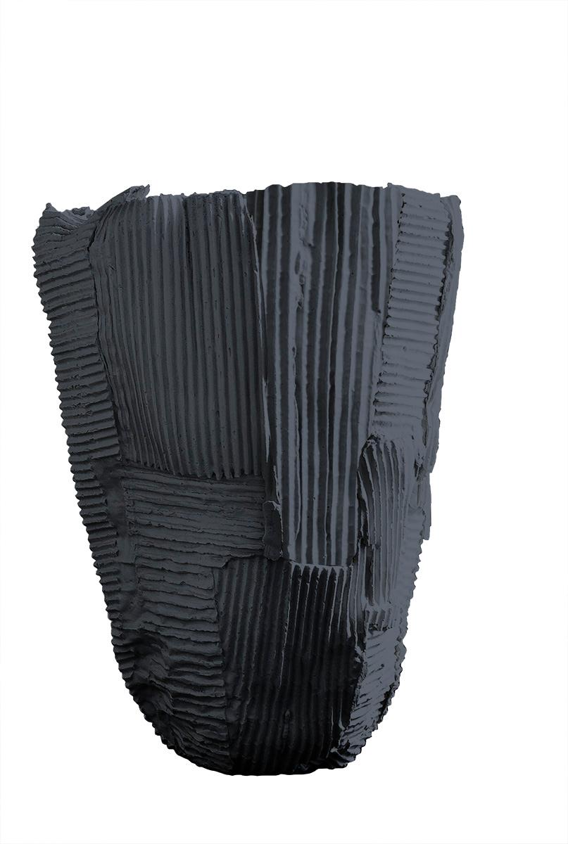 Sculptural yet subtle, this elegant tall vase will be a dynamic accent for a modern living or dining room. Reminiscent of a blooming flower, the tall silhouette with flared-out sides is entirely handcrafted of black paper clay, a compound that mixes