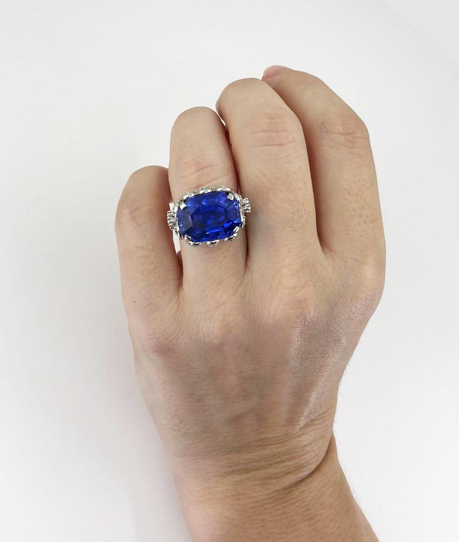 Contemporary Ceylon Sapphire Diamond Ring 14.67 cts in Platinum.

A magnificent, vibrant sapphire of Sri Lankan origin set the east-west direction. The gemstone is a hue of vivid, intense, velvet-like blue and has no indication of any heat