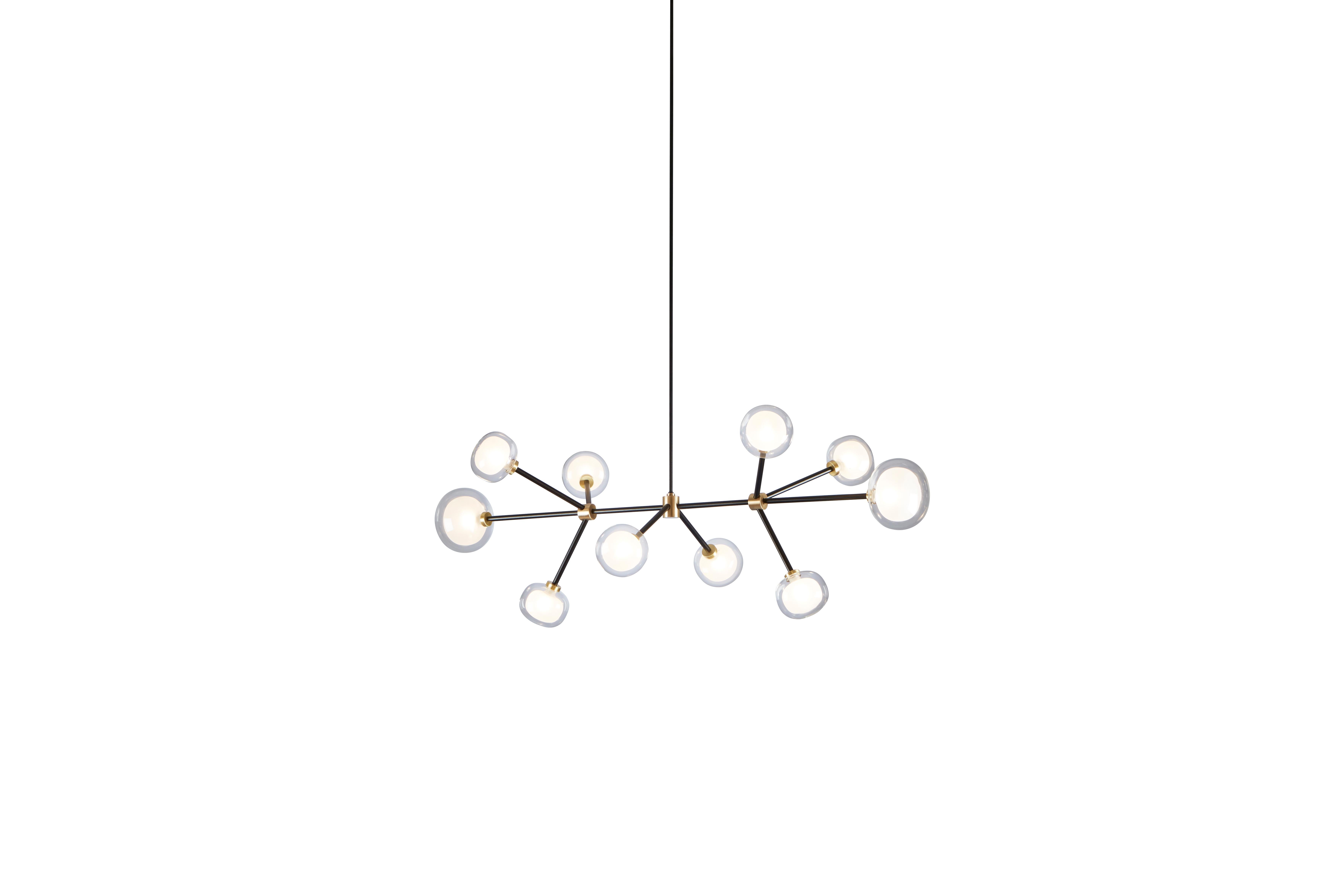 Chandelier Nabila 552.10 by Corrado Dotti x TOOY
10 Lights
UL Listed Compliant with US electric system

Model shown:
Finish: Brushed brass
Color: Clear glass
Canopy: Ø 13 cm

Lighting source : 10 x G9 220/240V

Pendant: Cable length 30/ 60 / 90 cm.