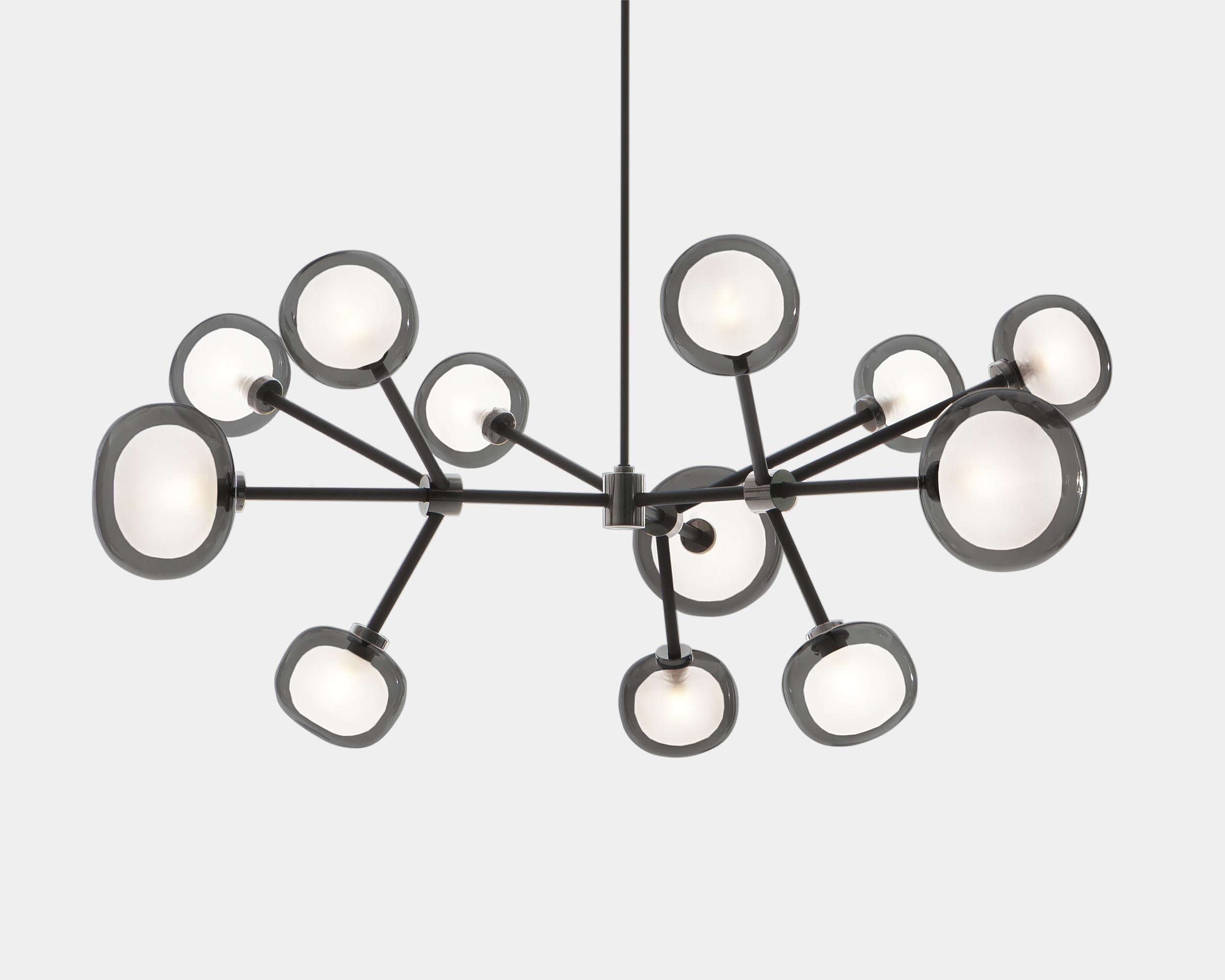 Chandelier Nabila 552.10 by Corrado Dotti x TOOY
12 lights
UL Listed Compliant with US electric system


Model shown: C2 + C41 + clear
Finish: Brushed brass
Color: Smoke glass
Canopy: Ø 13 cm

Lighting source : 12 x G9 220/240V

Pendant: Cable