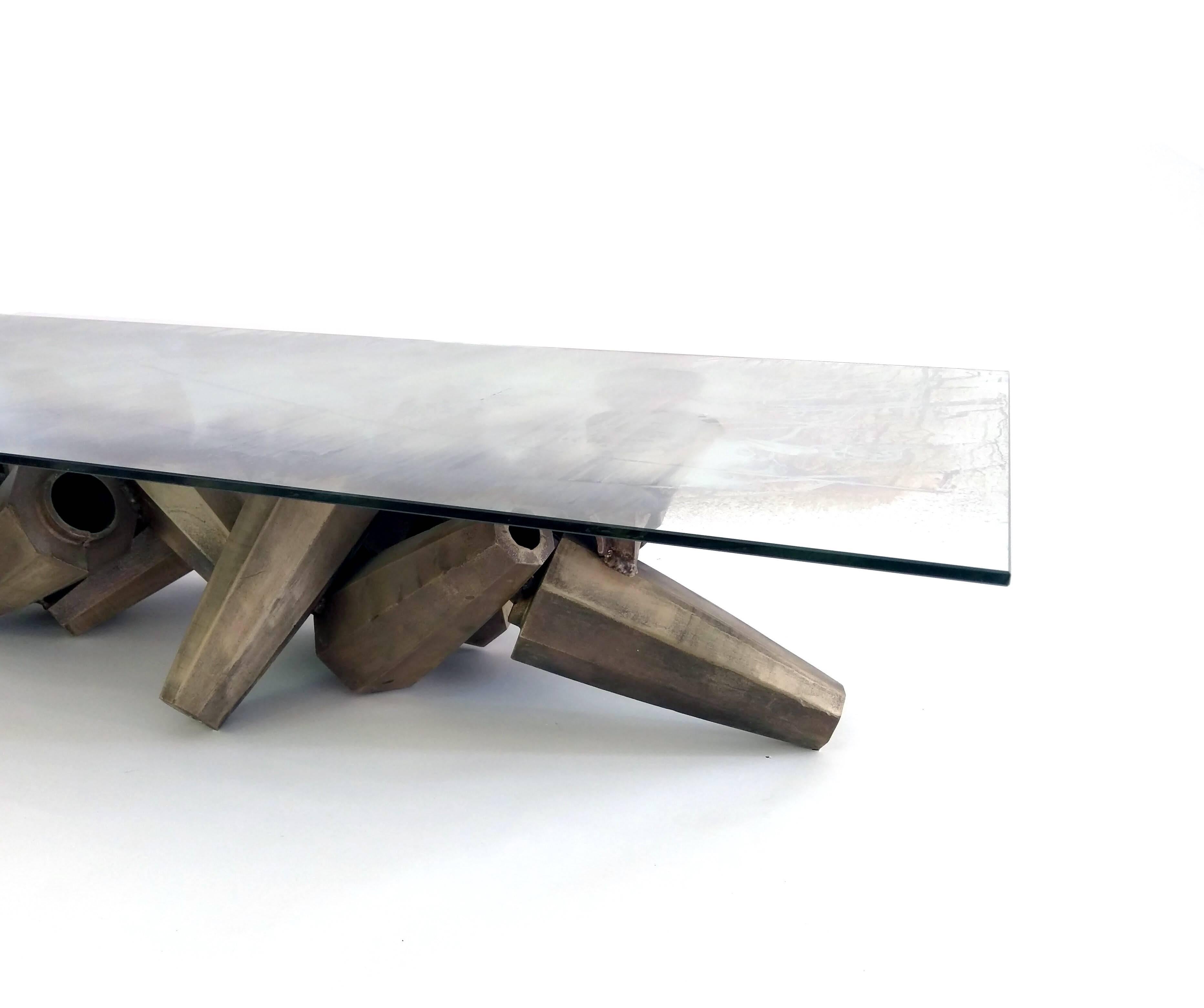 Gregory Nangle
Chaos Table, 2015-18
Silvered glass and silicon cast bronze
65 x 30 x 12 in

Chaos Table is a Brutalist style coffee table made by Philadelphia artist/designer Gregory Nangle. It is made of a 1950s vintage fused Italian cream glass