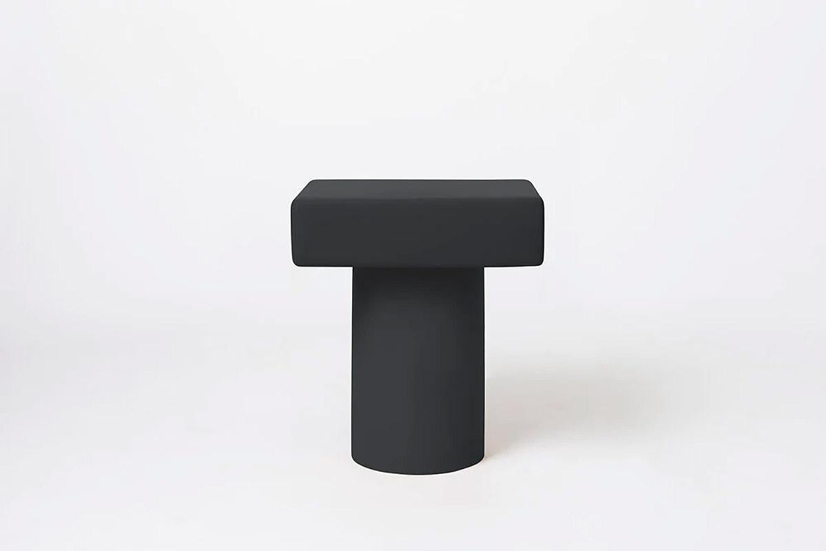 Contemporary wooden nightstand, Roly-Poly by Faye Toogood
This is shown in the charcoal wooden finish. 

A freestanding bedside table with a flush sliding drawer. A soft-edge storage unit stands atop a single stout column.

This product is
