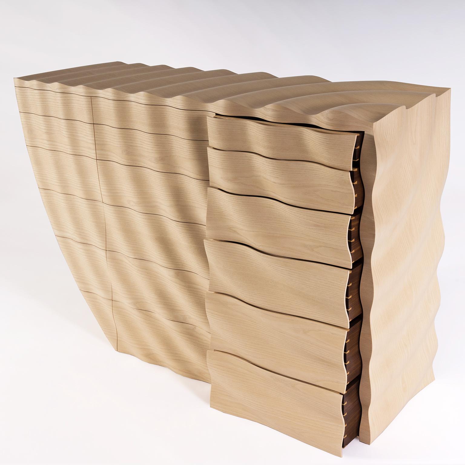The contemporary 'Ripples' chest of drawers by Edward Johnson forms part of his Ripples Collection. Inspired by the action of a stone dropping into water, the principal intention was to produce a surface that could replicate the fluidity of water