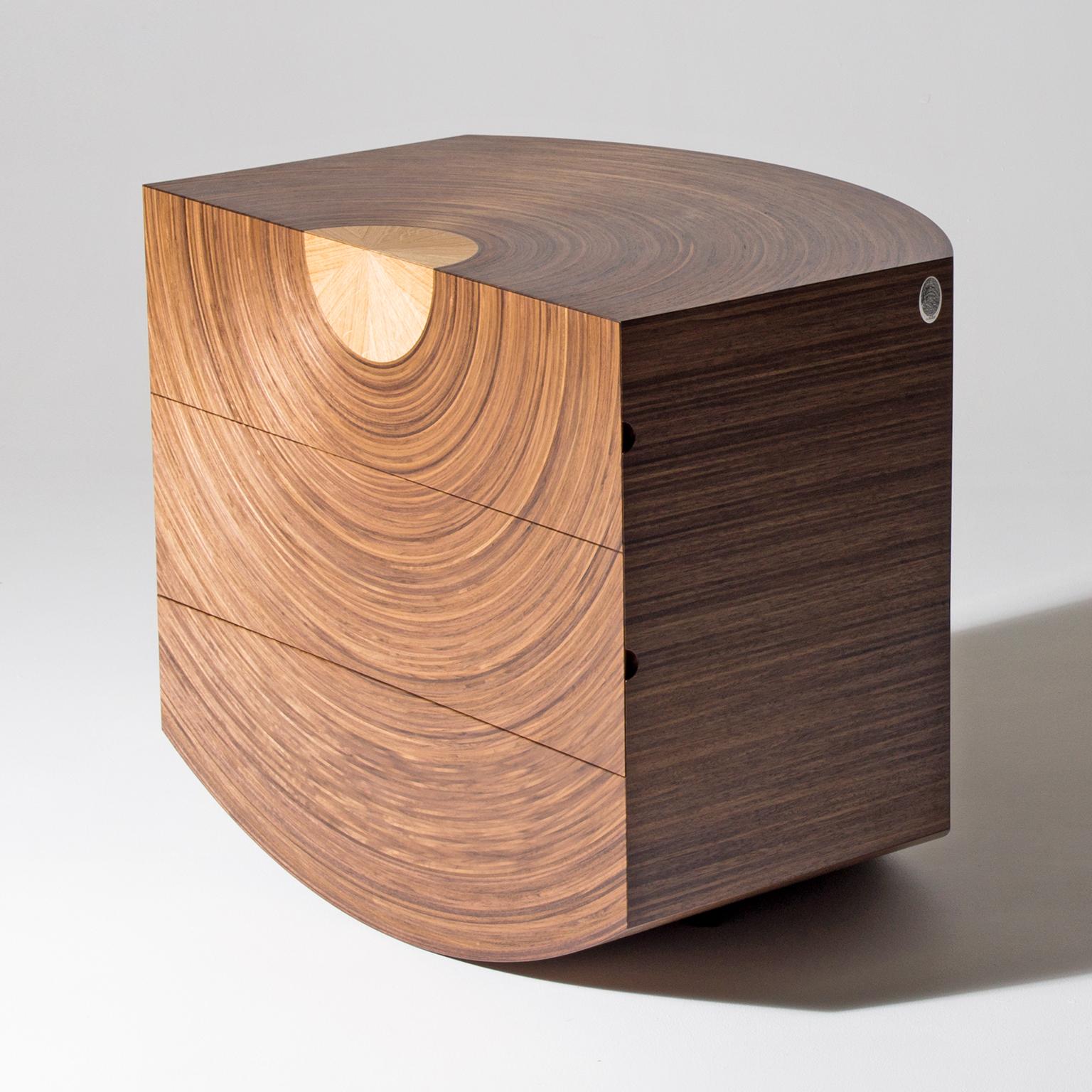 The contemporary ‘Centrum’ chest of drawers by Edward Johnson is made in walnut and oak. The walnut ‘Murano’ veneer radiates from a central star-burst oak core on the top and front. 

This delightful chest of drawers is all about symmetry and can