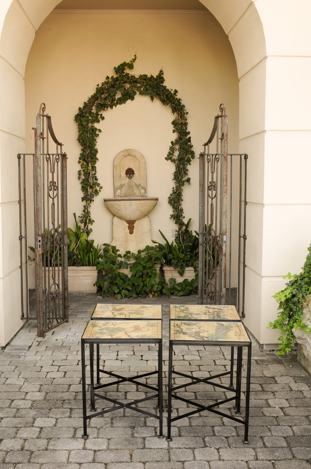 A contemporary chinoiserie style side table made from an antique 1870s screen depicting a monkey and a stag, mounted on a custom iron stand. We currently have four tables available of two slightly different dimensions available. This stylish coffee