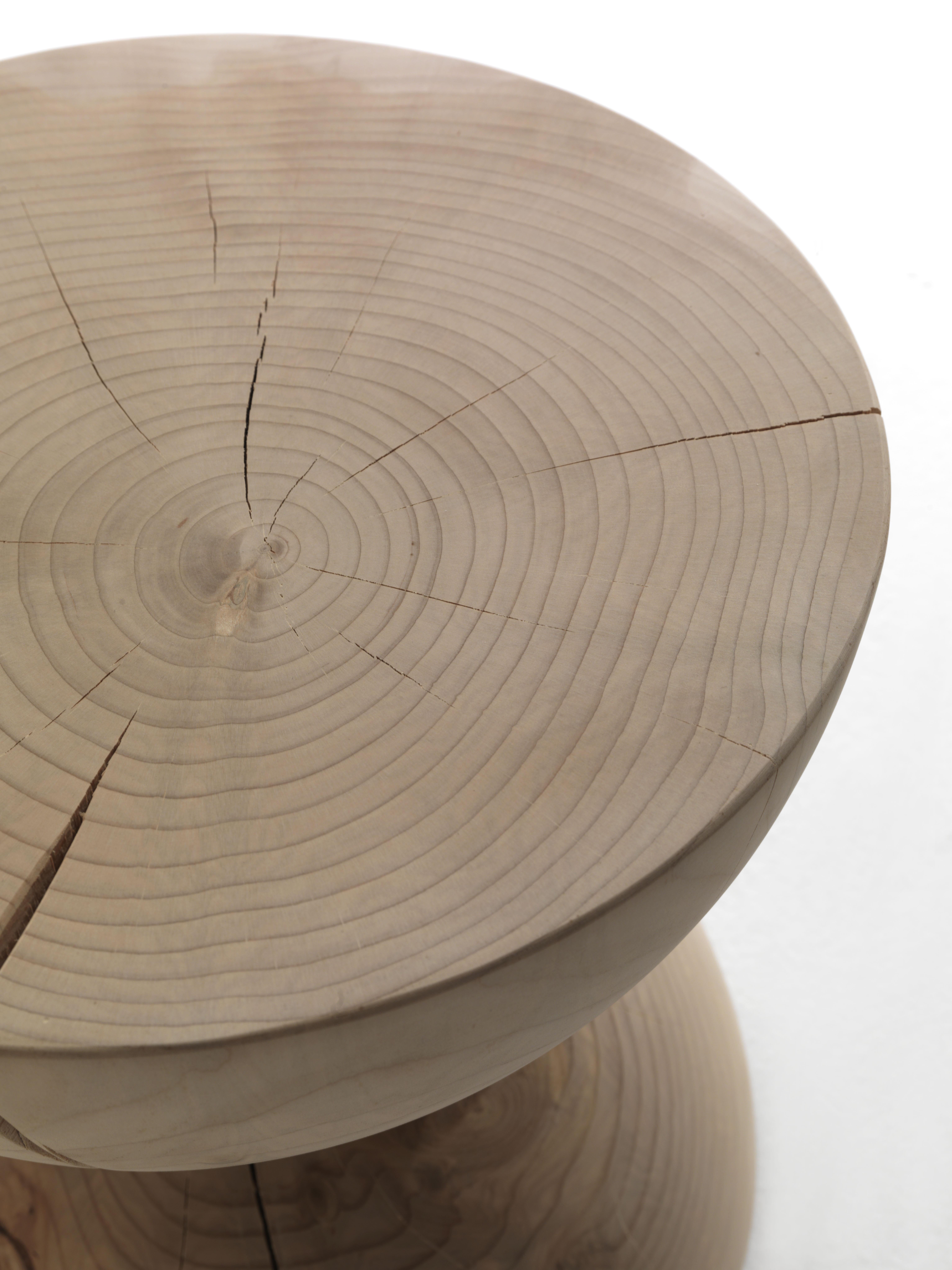 Stool made of a single block of scented cedar that features two semicircles positioned one on top of the other to form an hourglass. Designed by Mario Botta.