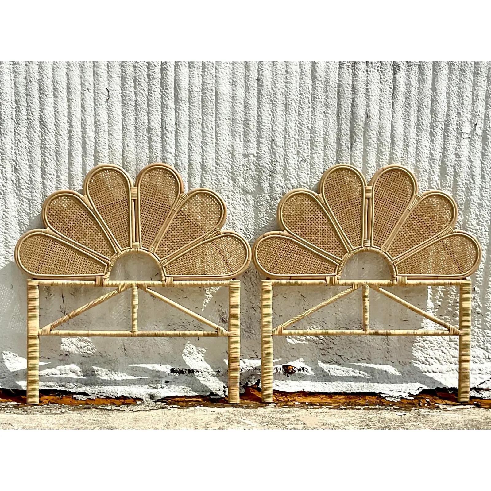 A fantastic pair of Coastal twin headboards. Beautiful bent scalloped rattan with inset cane panels. Acquired from a Palm Beach estate.