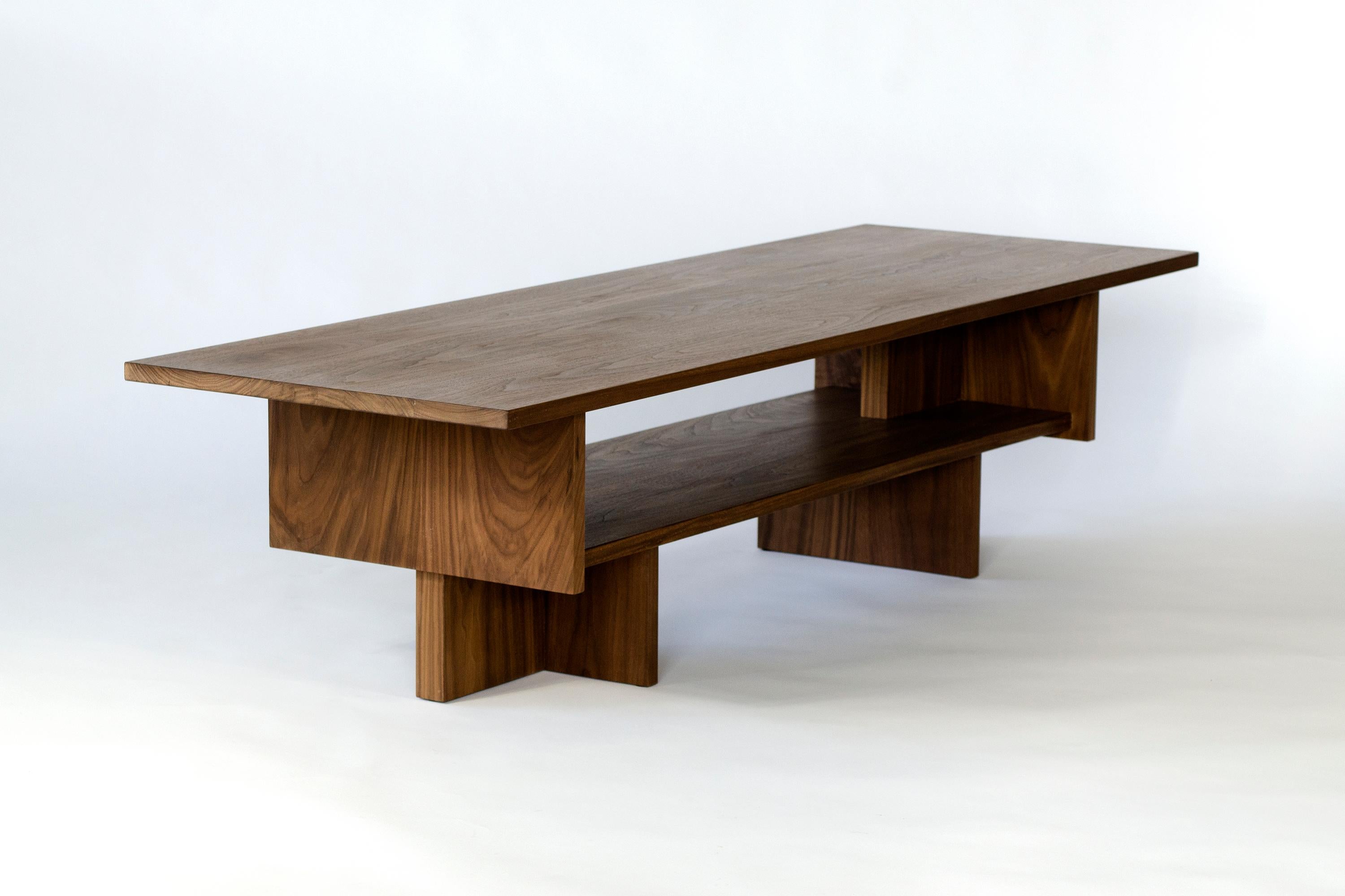 Ballast table, named for the two hefty uprights which form its structure, is a generously sized coffee table. Careful attention to proportion and the arrangement of parts give the Ballast table it's characteristic form with nooks for storing books
