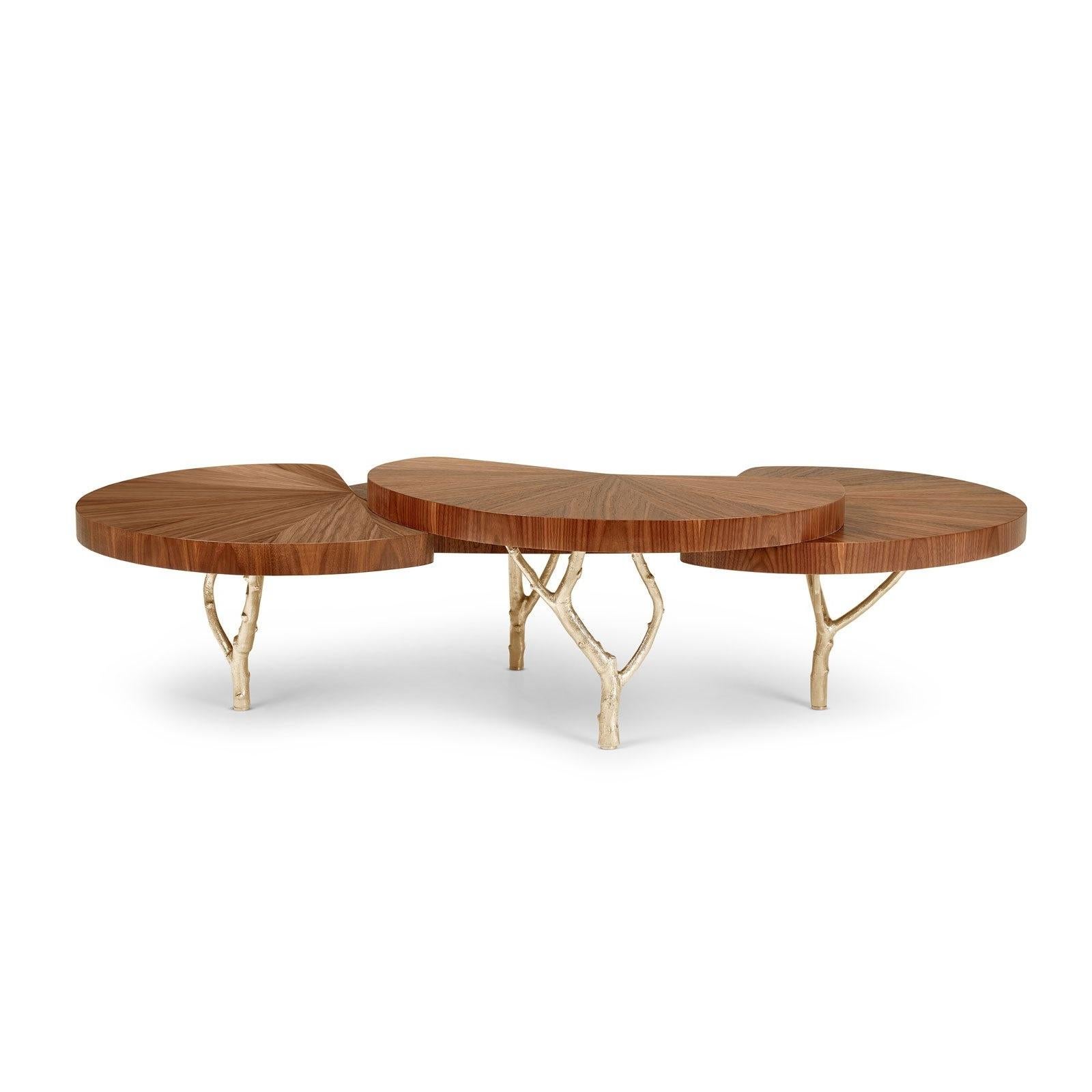 Springing from a low base made of fig tree branches in brass casting, this coffee table creates a dynamic presence from its layered tops and the handcrafted wood marquetry. A delicate balance for a living space.
Top: American Walnut.
Legs in cast