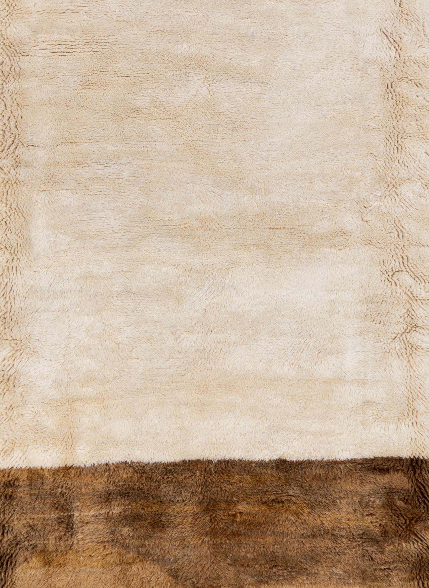 Woven in Morocco using techniques that have been around for decades, this handmade rug features a warm cream and light mocha color blocking. Can also be made to order in your desired size. 

Wear Guide: New

Wear Notes:
Vintage and antique rugs