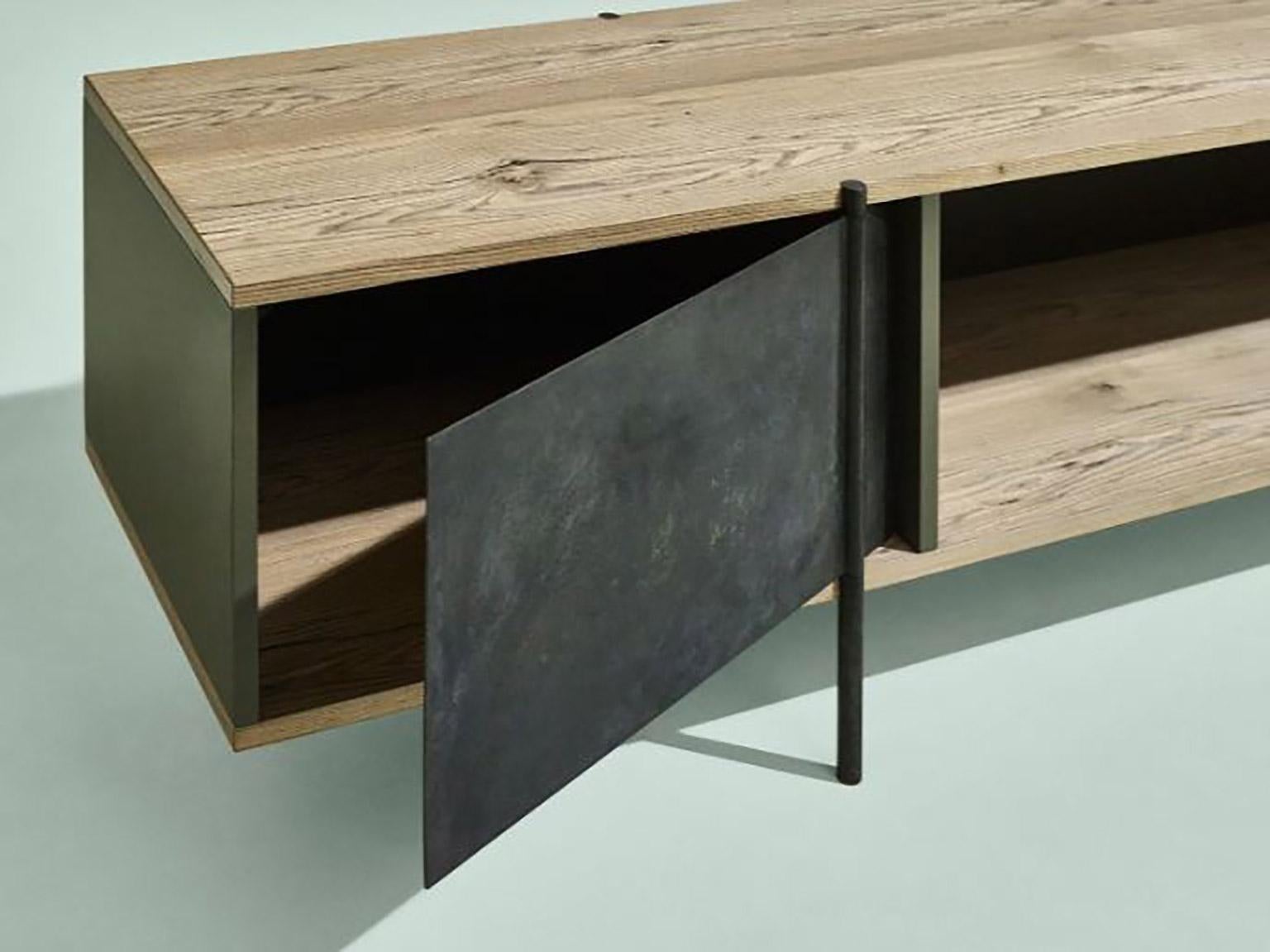 SEM pivot contemporary collection, console, simple and sculptural. The supporting structure is a rigid system of metal tubes to which are added shelves in beautiful stone elm wood combined with various lacquered containers. The pivoting mechanism