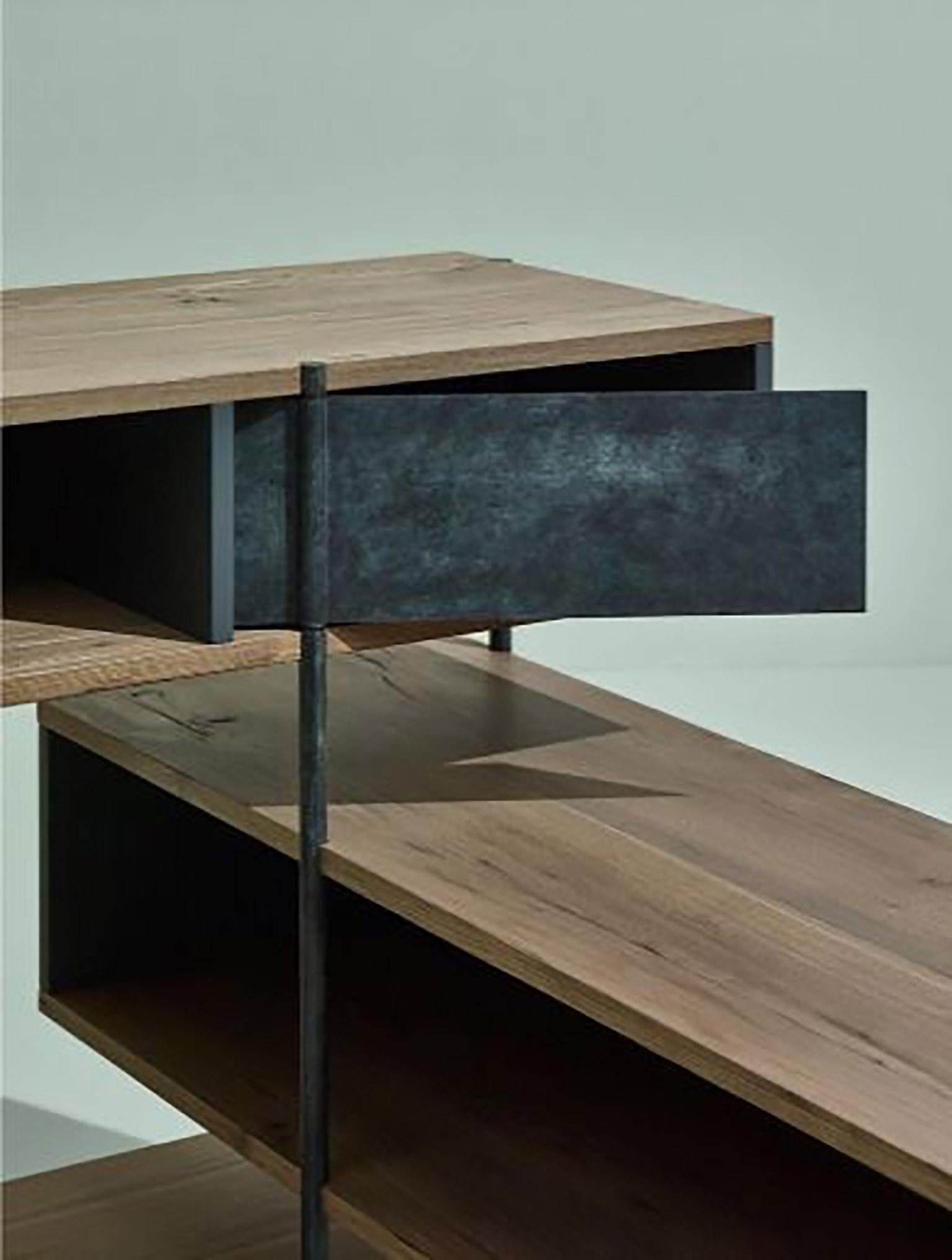 SEM Pivot collection corner console, simple and sculptural. The supporting structure is a rigid system of metal tubes to which are added shelves in beautiful stone elmwood combined with various lacquered containers. The pivoting mechanism for