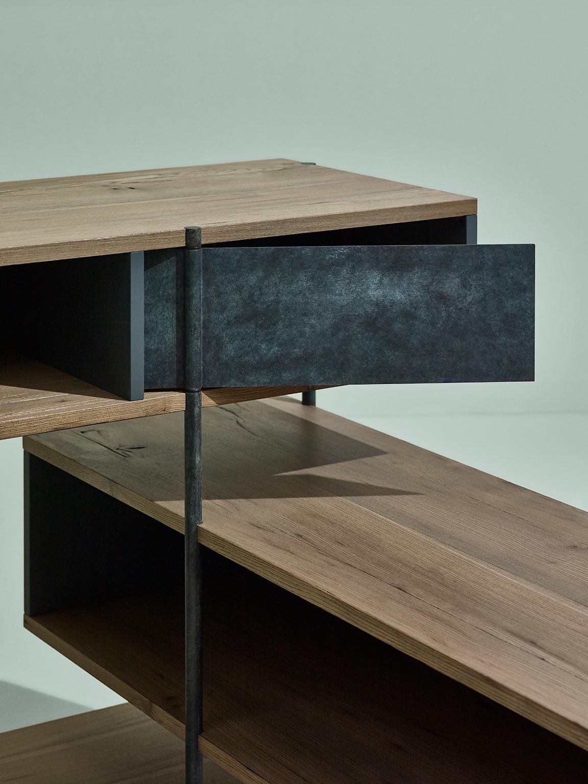 Sem Pivot collection corner console, simple and sculptural. The supporting structure is a rigid system of metal tubes to which are added shelves in beautiful stone elmwood combined with various lacquered containers .The pivoting mechanism for