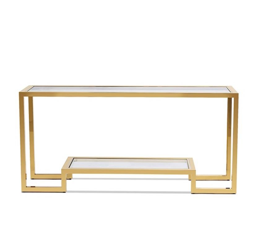Contemporary rectangular console table with gilt metal frame and glass top and a centered shelf.