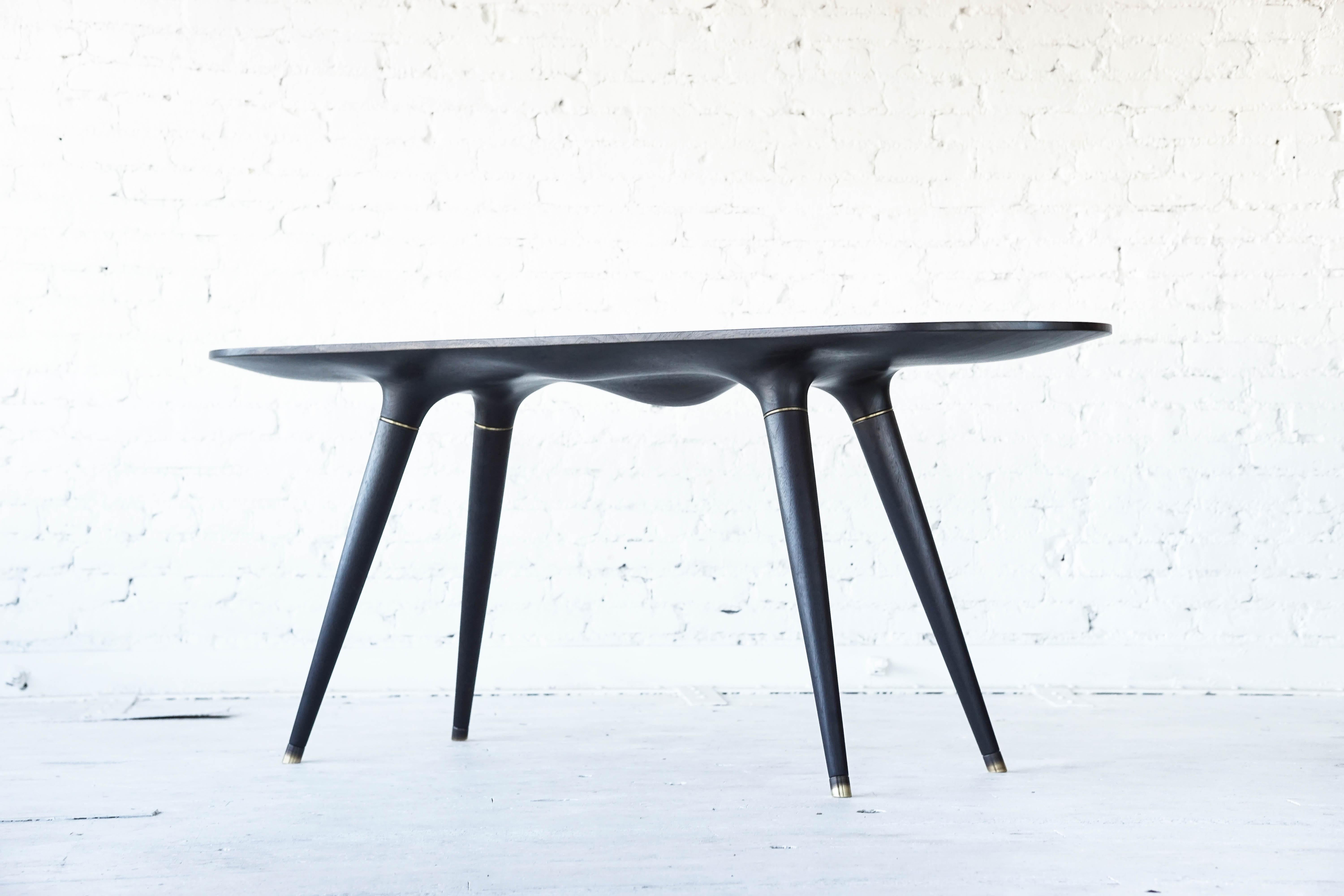 Ebonized dining table 001 from Series001 by Vincent Pocsik.

Vincent Pocsik finds the balance between old and new fabrication techniques working in conjunction to find an anatomical form that creates its own presence. Series 001 is about finding