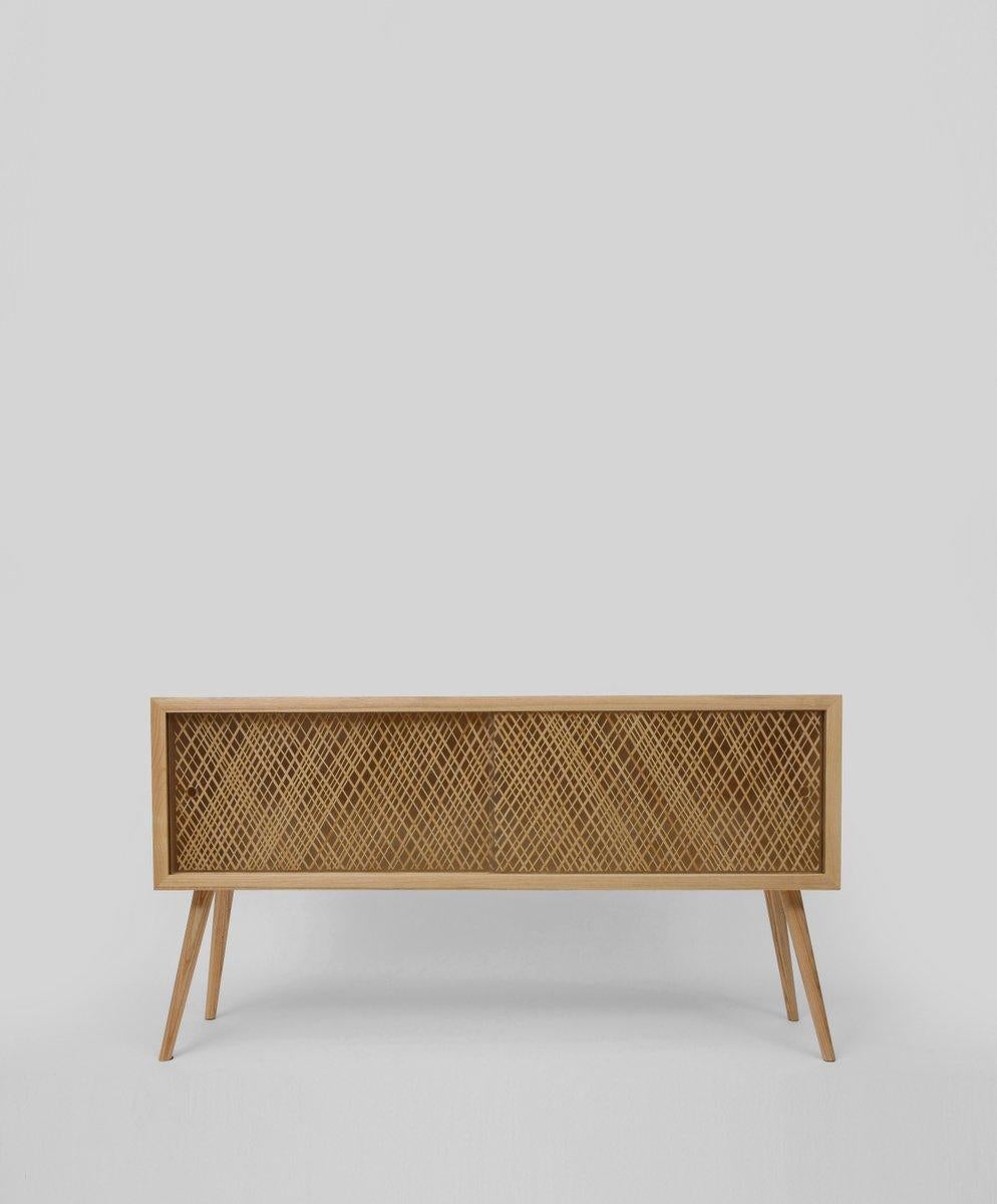 The minimal console is crafted from solid ash and features a sliding panel with textured straw weave inlay in clear resin. The natural finished piece weighs 80 kg.
Handcrafted by skilled artisans.
Materials: Ash, resin, straw
Finishes: