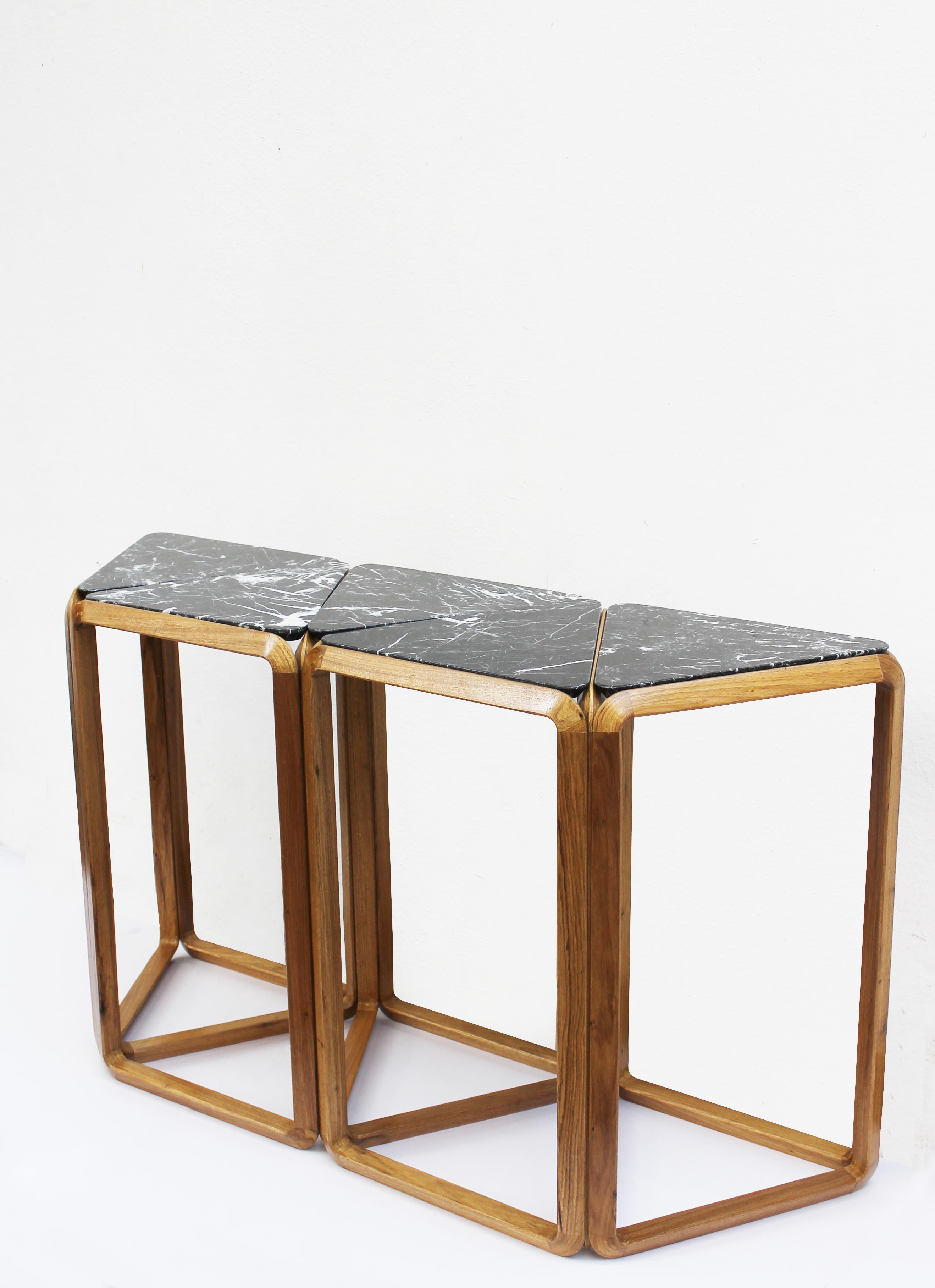 Wood (Brazilian freijó) and Marble (spanish nero marquina) Console table - five tops

Base of Brazilian Freijó wood and loose tops in marble nero marquina.
Although a solid object, the emptiness is also part and give name to the collection - void