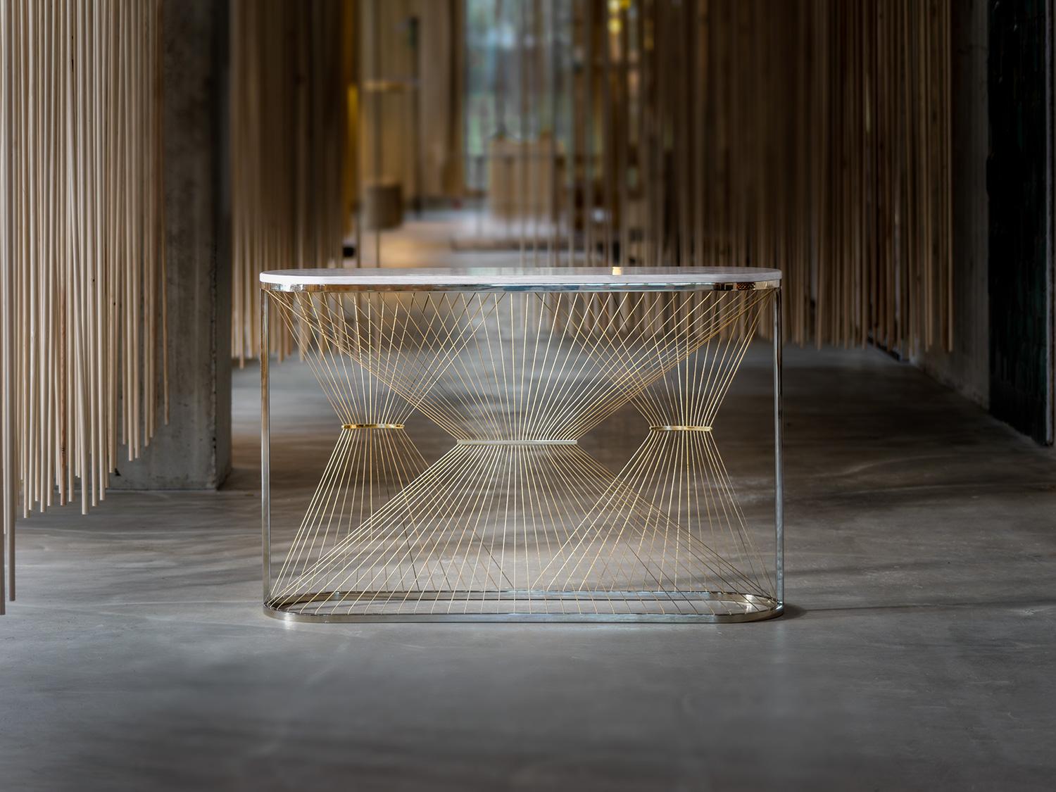 Aegis-P console table is made to order using solid stainless steel, brass plates, marble and gold steel wire. A modern contemporary design using only the finest materials and manufacturing methods; it takes 10 hours to carefully carve every part of