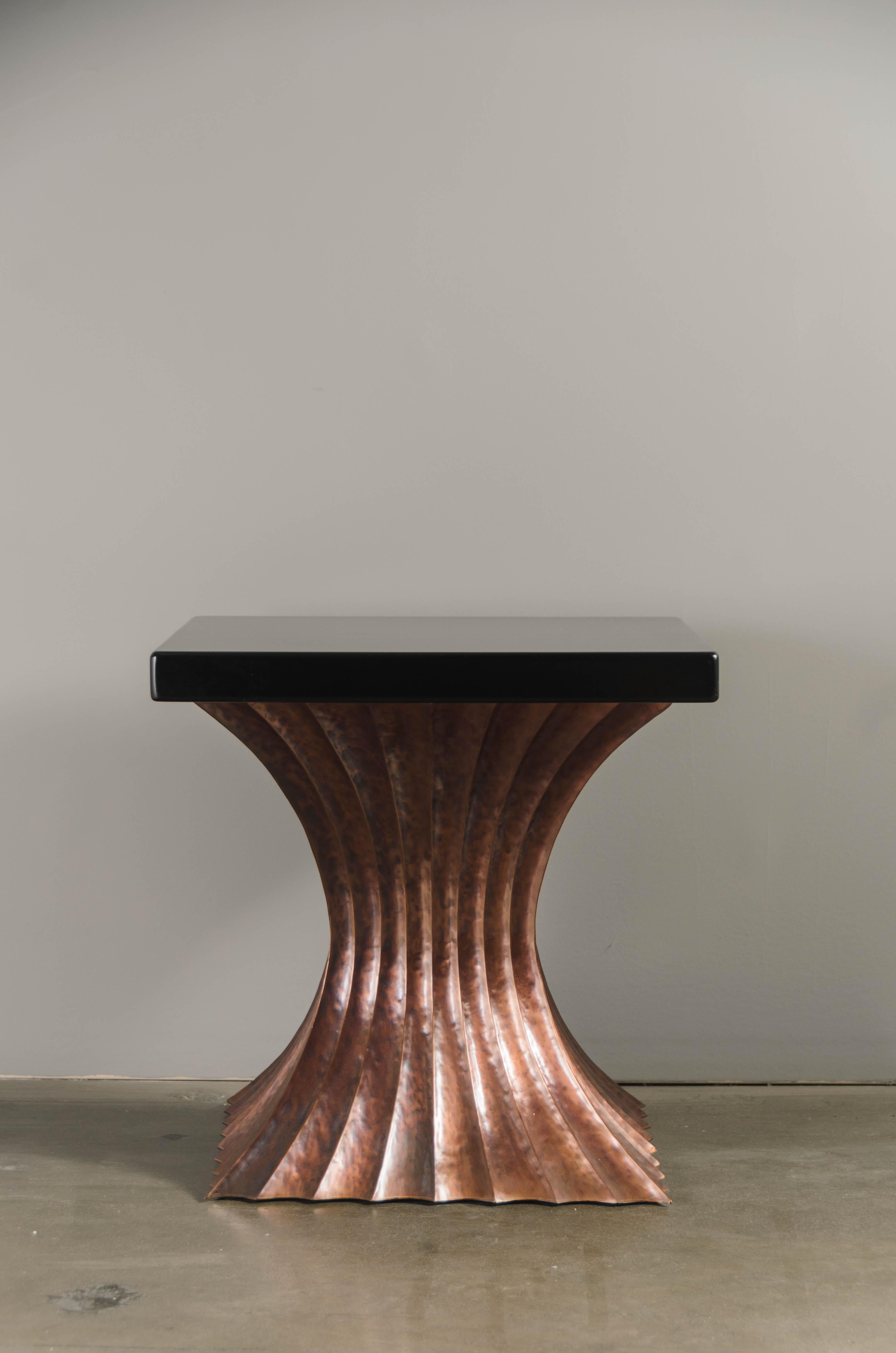 Square fluted table 
Antique copper 
Black lacquer top
Hand Repoussé
Lacquered
Limited edition

Repoussé is the traditional art of hand-hammering decorative relief onto sheet metal. This technique involves using a hammer and various shaping