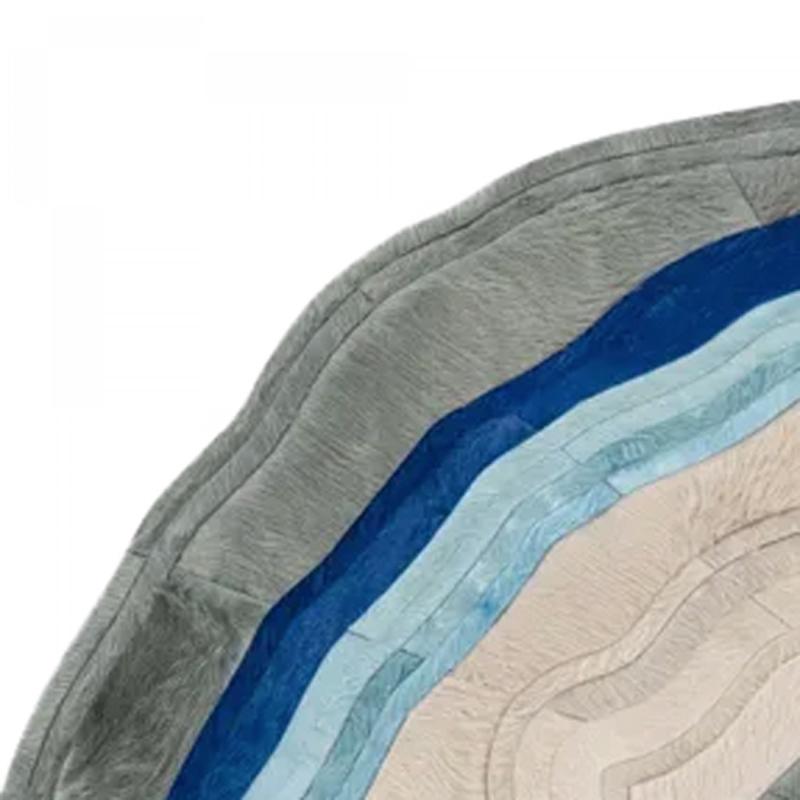 Contemporary American cowhide rug in shades of blue, beige, and gray. (RORIC TOBIN)