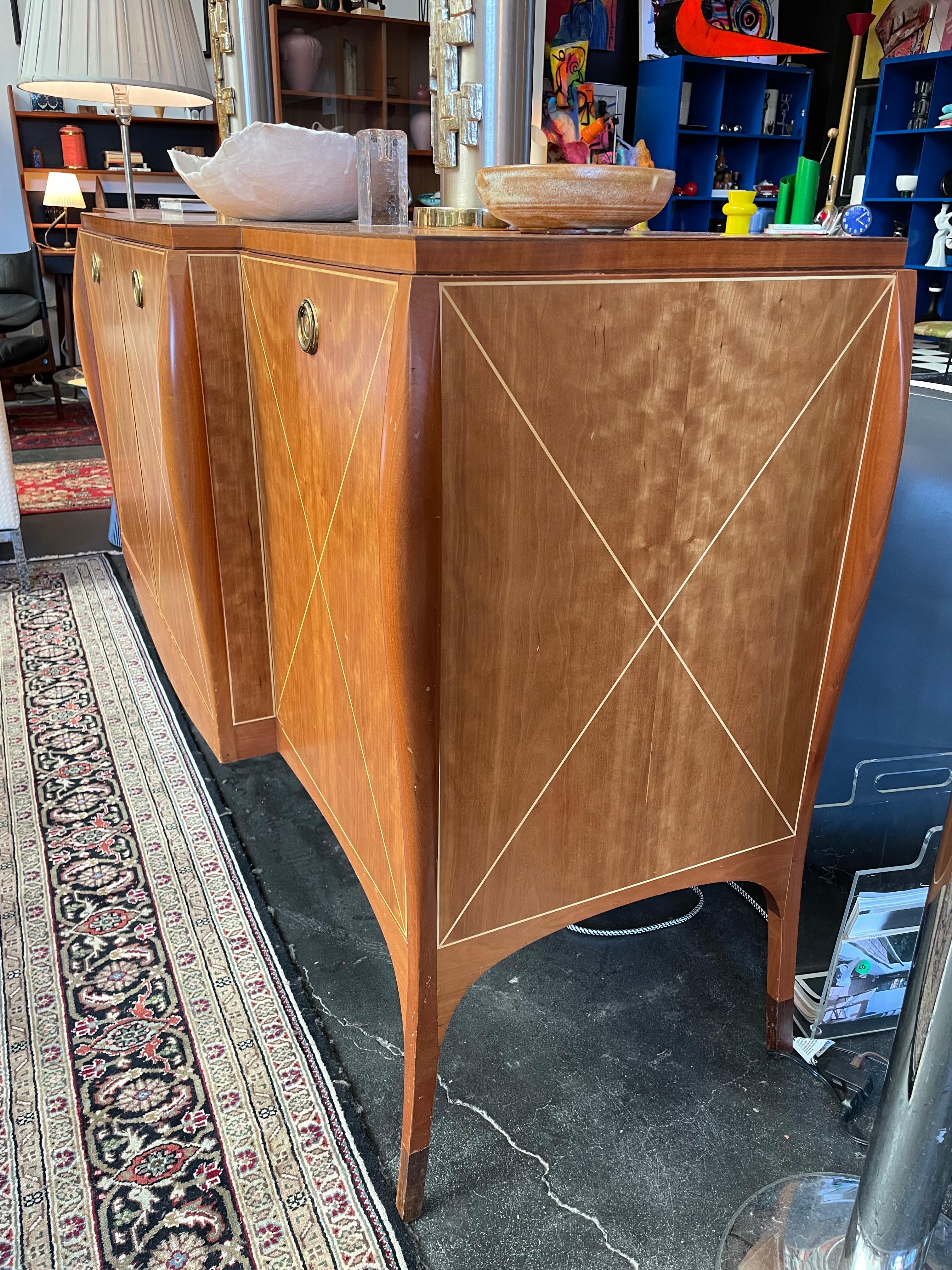 Beautiful contemporary credenza custom made by Margaret Rodgers. Made in Philadephia. Cabinets on each side with shelving in center unit including a drawer.
