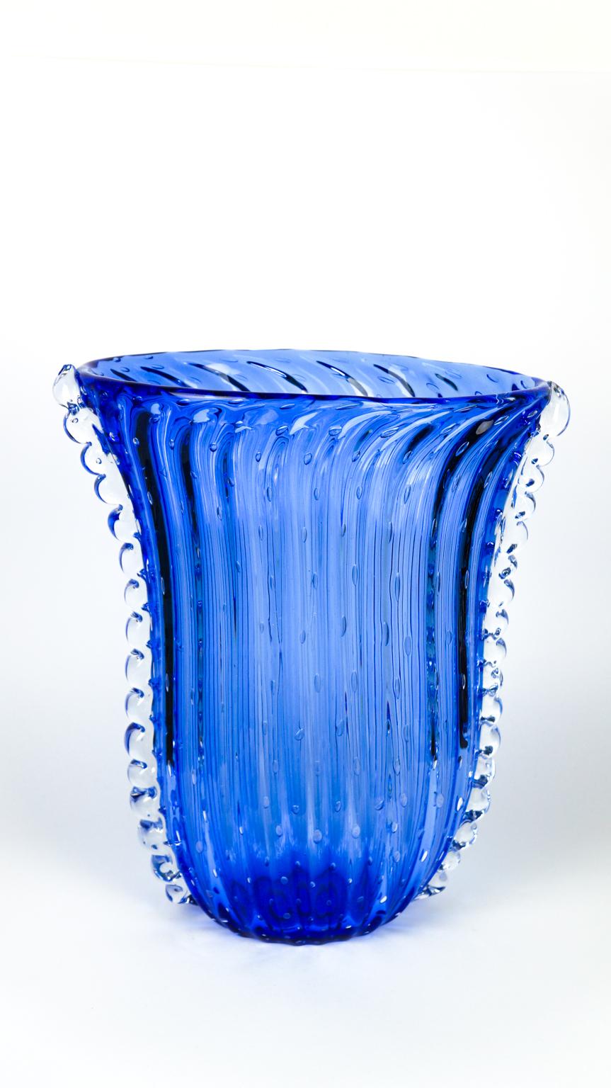 Handmade blue Murano glass vase with internal bubble decorations and lateral crystal.
This fantastic Art Deco style artwork will add an extra touch of class to your environment.
Vase signed with engraving: Made Murano Glass

 Murano glass vase