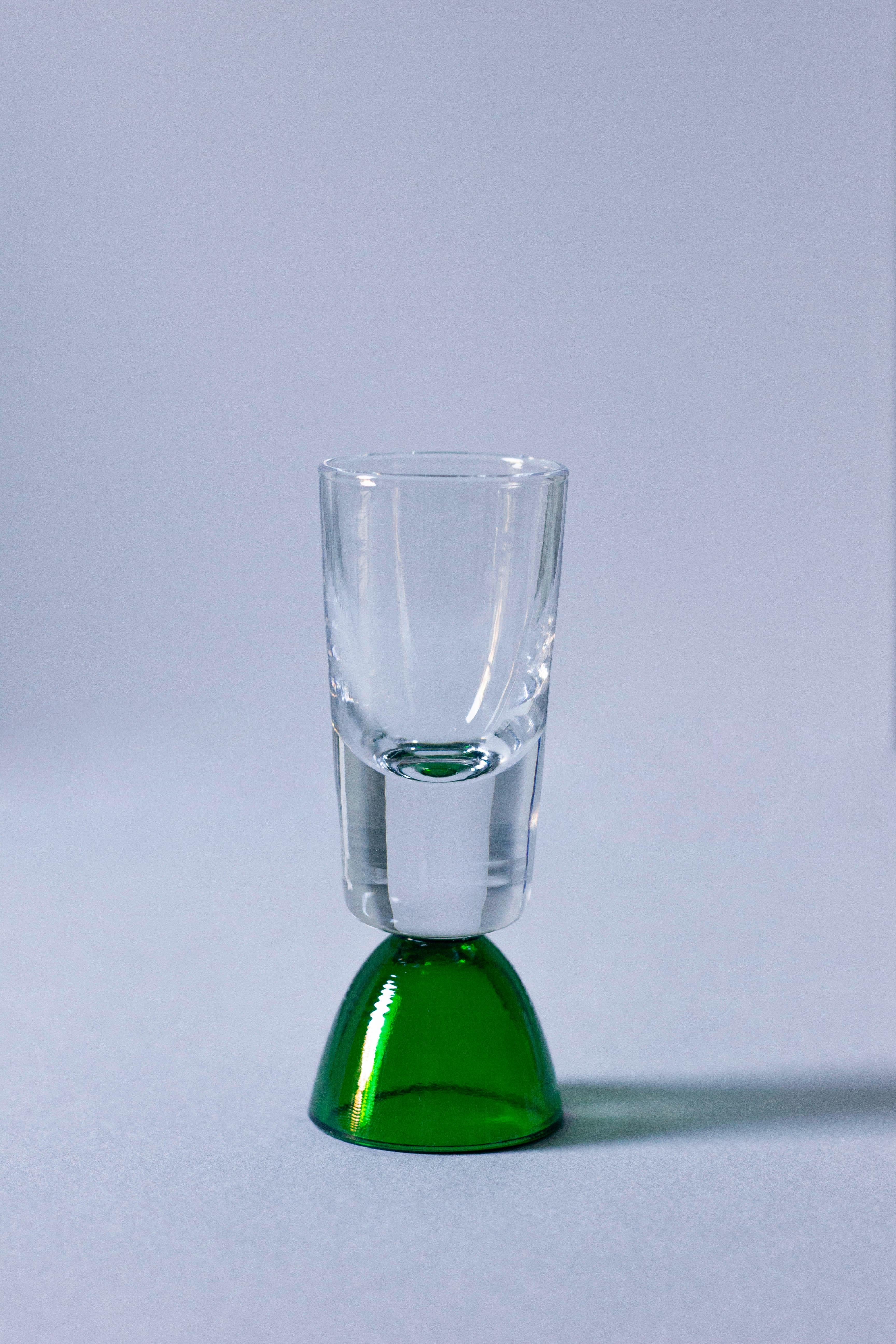 Enjoy a shot with this tequila glass, handcrafted in Tuscany by skilled artisans. Ideal for savoring tequila, mezcal, or other fine spirits, this glass from the wonder crystals collection comes in a clear/green adding sophistication to your table
