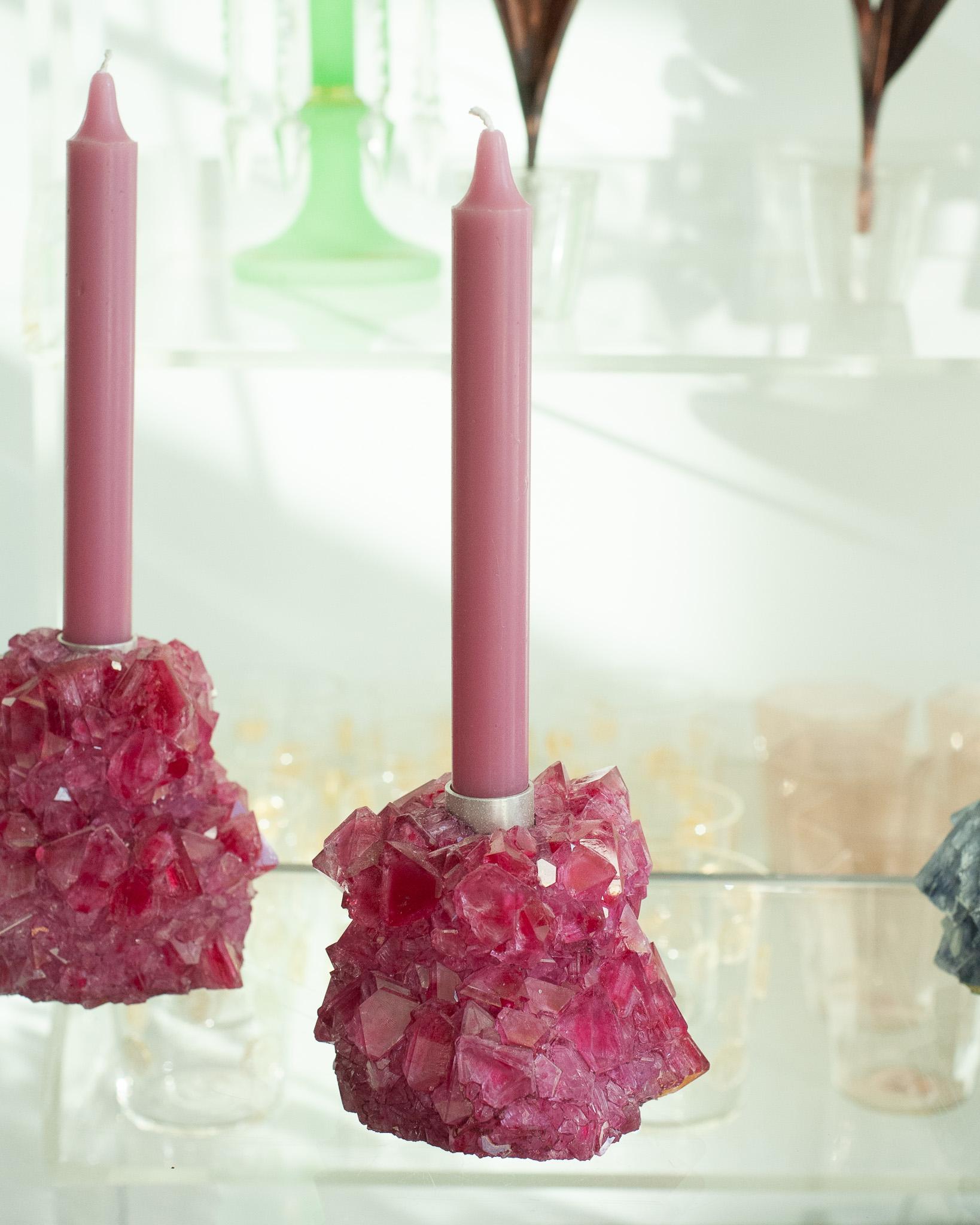 A stunning crystallized candleholder in fuschia, by artist Isaac Monté. This original work of art is produced through fascinating process, combining science and art. By dissolving minerals and oxides in hot water, the artist forms a solution that