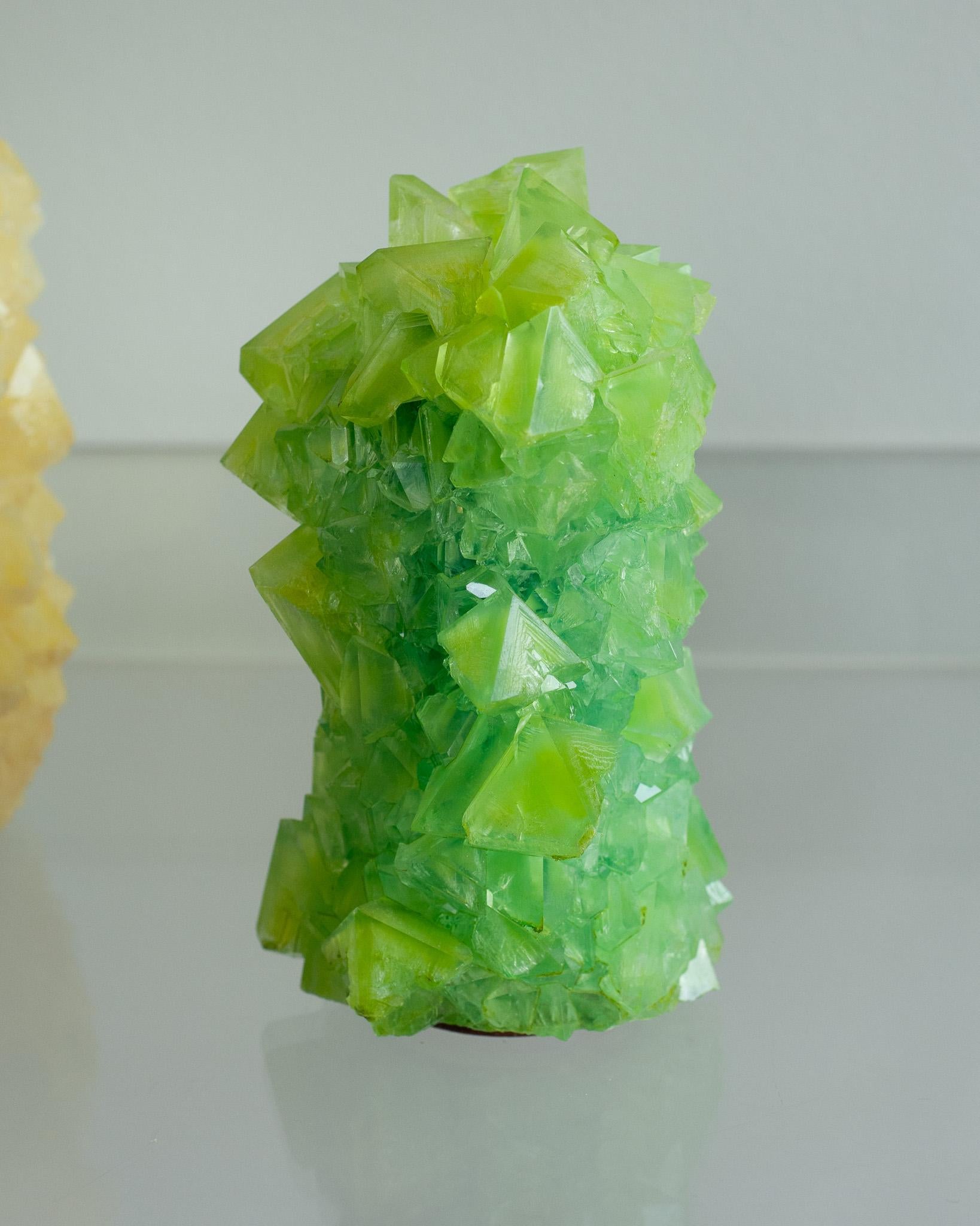 A stunning crystallized vase in green, by artist Isaac Monté. This original work of art is produced through fascinating process, combining science and art. By dissolving minerals and oxides in hot water, the artist forms a solution that slowly