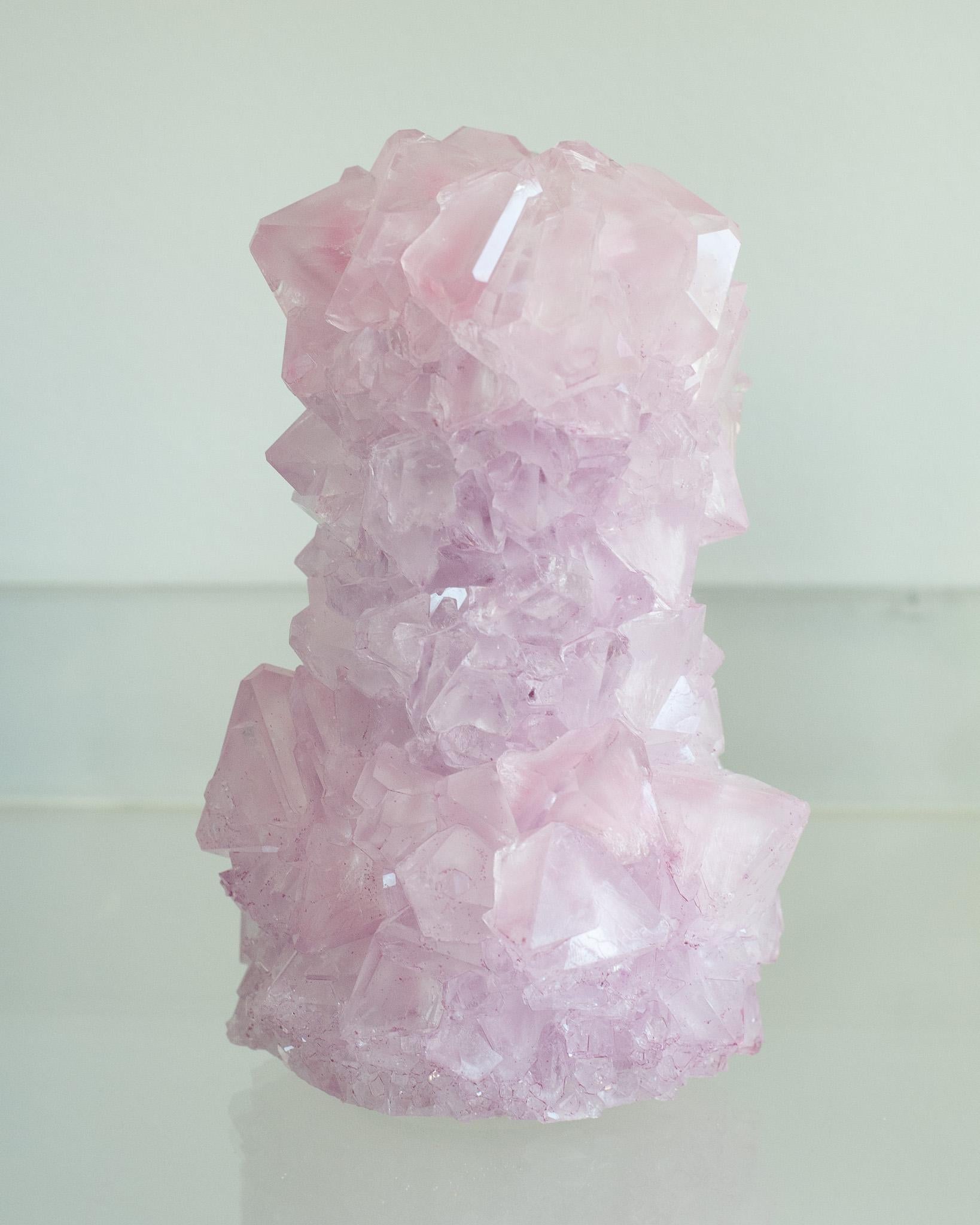 A stunning crystallized vase in soft pink, by artist Isaac Monté. This original work of art is produced through fascinating process, combining science and art. By dissolving minerals and oxides in hot water, the artist forms a solution that slowly