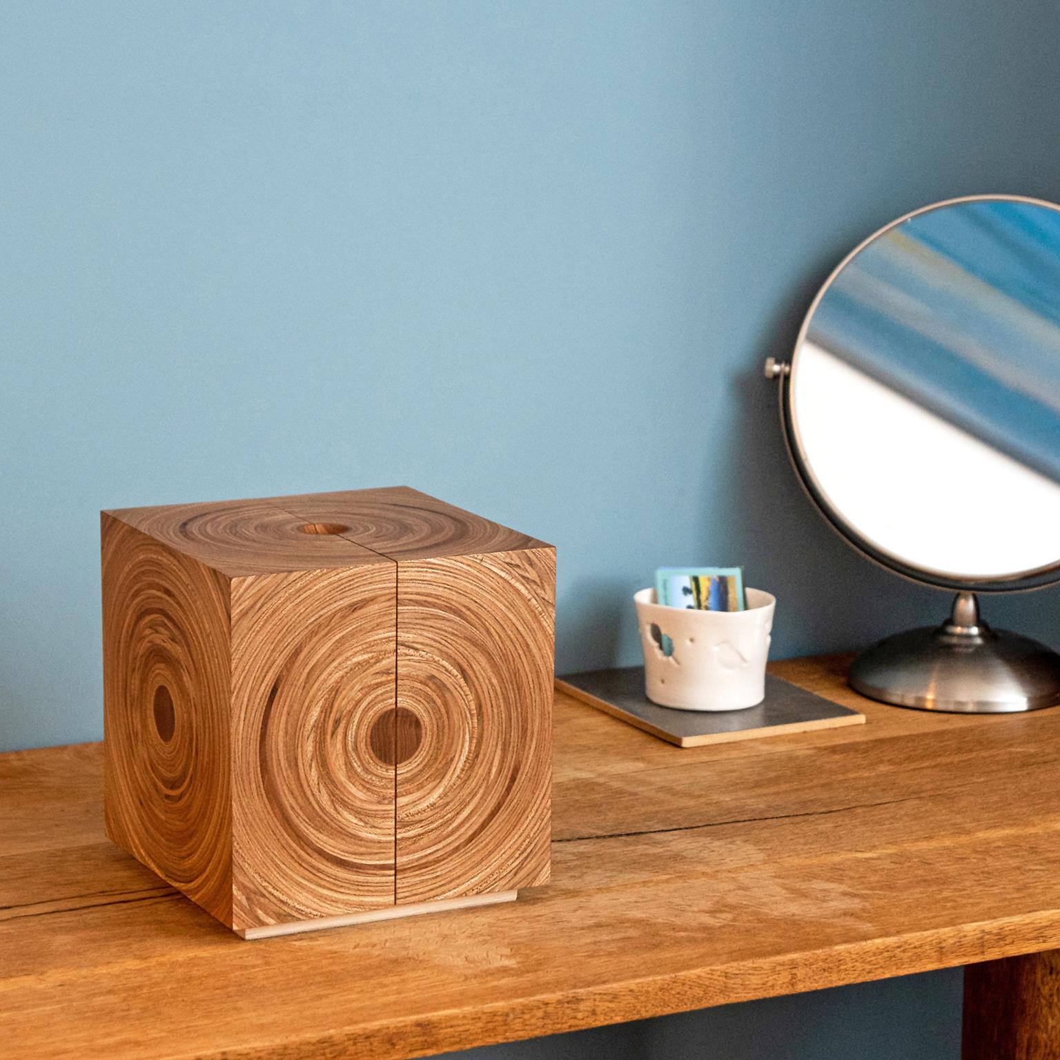 The contemporary cubed 'Squaring the Circle' jewellery box by Edward Johnson is made in elm and fumed oak with a magenta suedette fabric.

Each side of the jewellery box is made from Edward’s circular ‘Murano’ veneers with each surface reminiscent