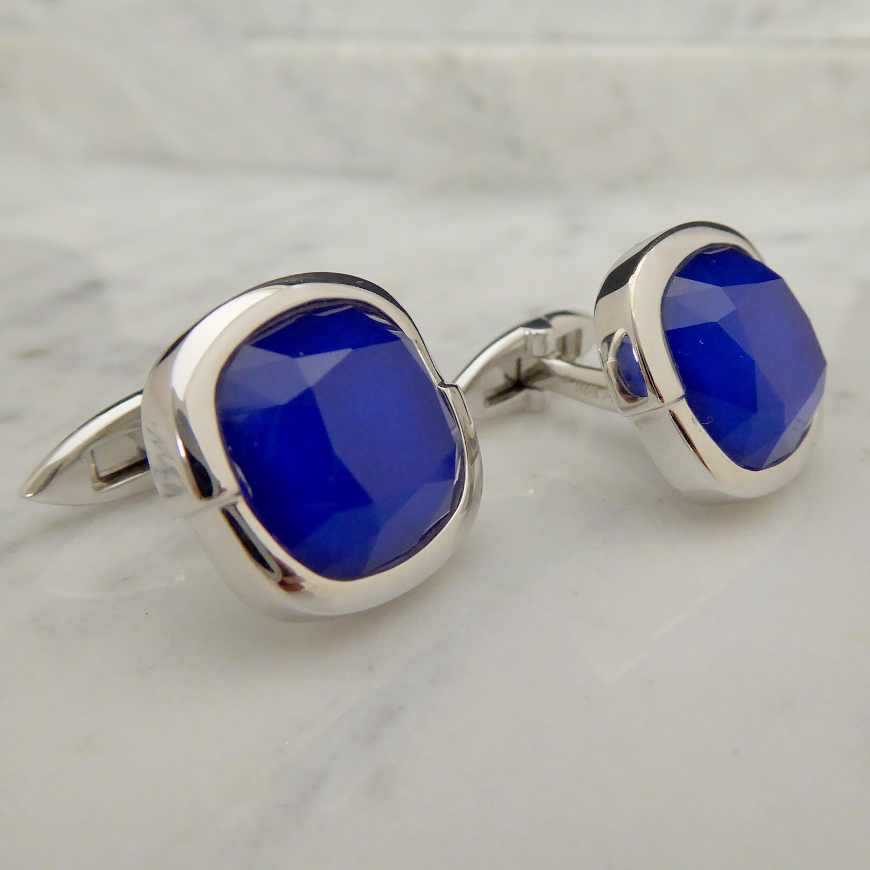 A very handsome pair of 18ct white gold and blue quartz cufflinks from the renowned celebrity jewellery designer, Stephen Webster.  Created with a cobalt blue cushion shaped quartz set within a polished white panel of two halves set slightly one