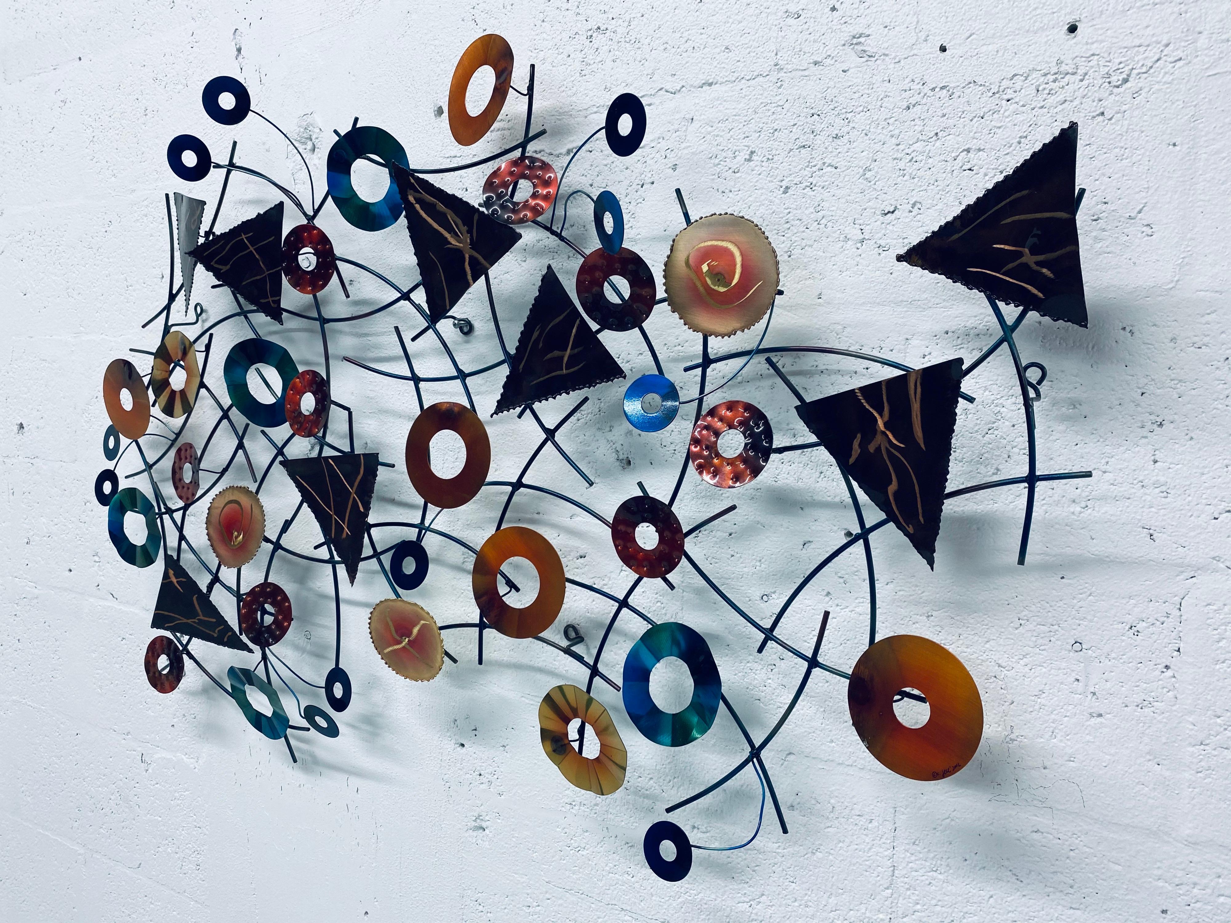 Contemporary mixed-media wall art sculpture fabricated by the artisan house Curtis Jere (C. Jere Artisan House). Dated 2002.
