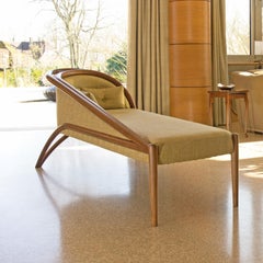 Contemporary Curved Chaise Longue made in Walnut with Green Upholstery Fabric.