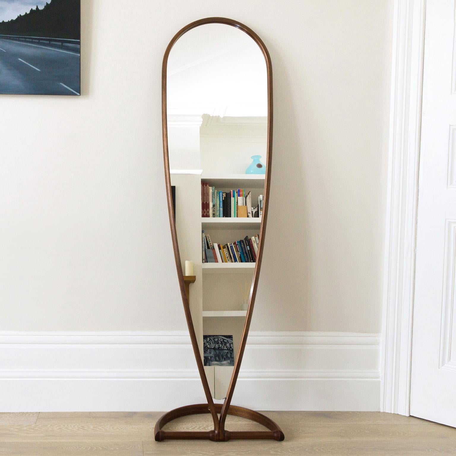 The contemporary full-length ‘Chichester Mirror’ has a beautiful, inverted tear-drop frame made from one continuous length of Walnut timber. The frame and base join together on a rotating swivel joint that allows the mirror to lean against the wall