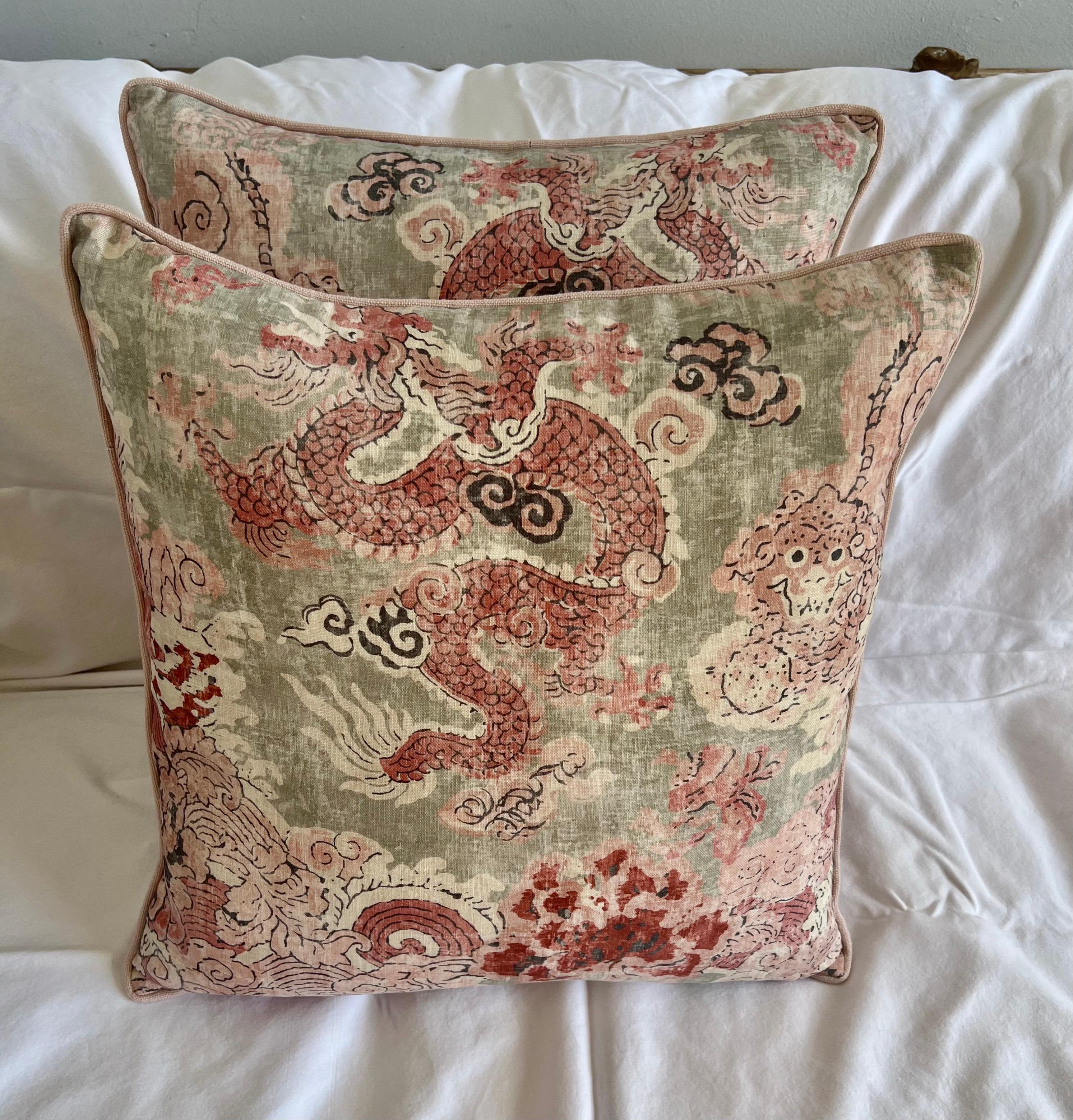 Pair of custom pillows made with printed cotton Chinoiserie style fabric depicting dragons and other mythological creatures. Linen backs, down inserts.