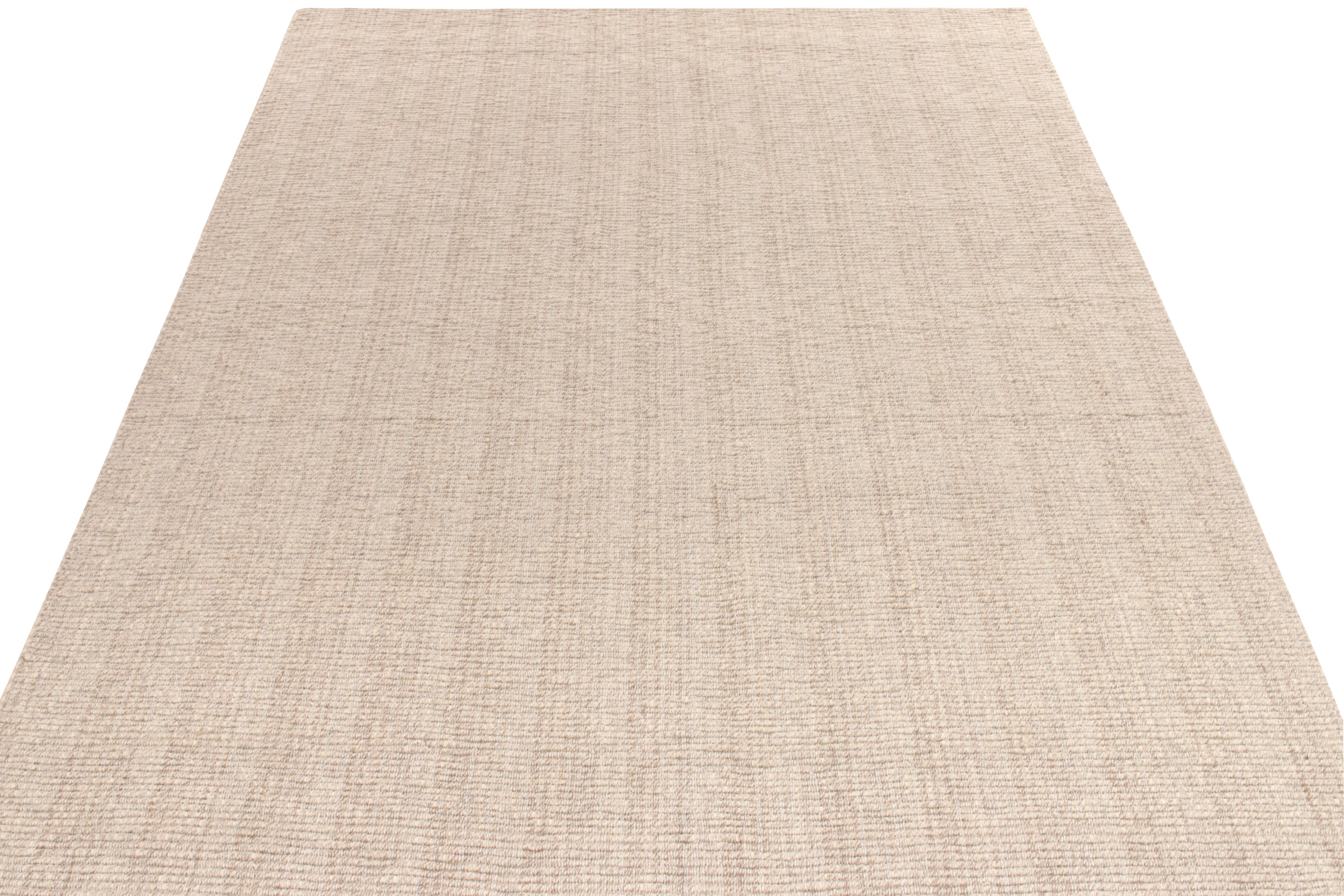 Tissé à la main en laine, ce tapis à tissage plat personnalisé de notre collection Kilim & Flatweave présente des rayures en beige et en brun pour un style contemporain distinctif. Exemplaire de ce 9x12 portant la force structurelle et la résistance